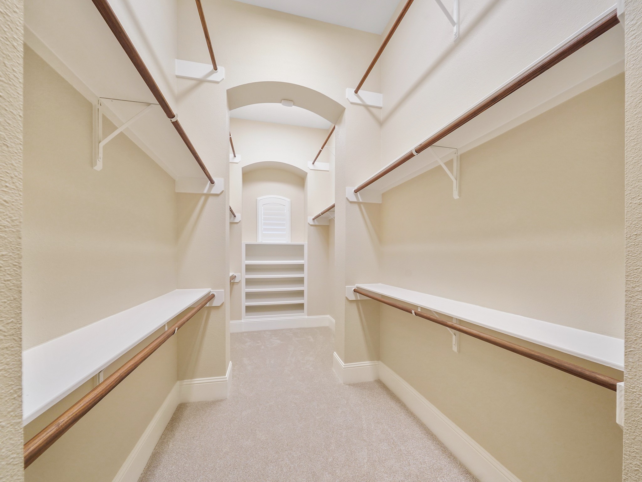 An expansive walk-in closet with built-in storage keeps the primary suite feeling organized and composed.