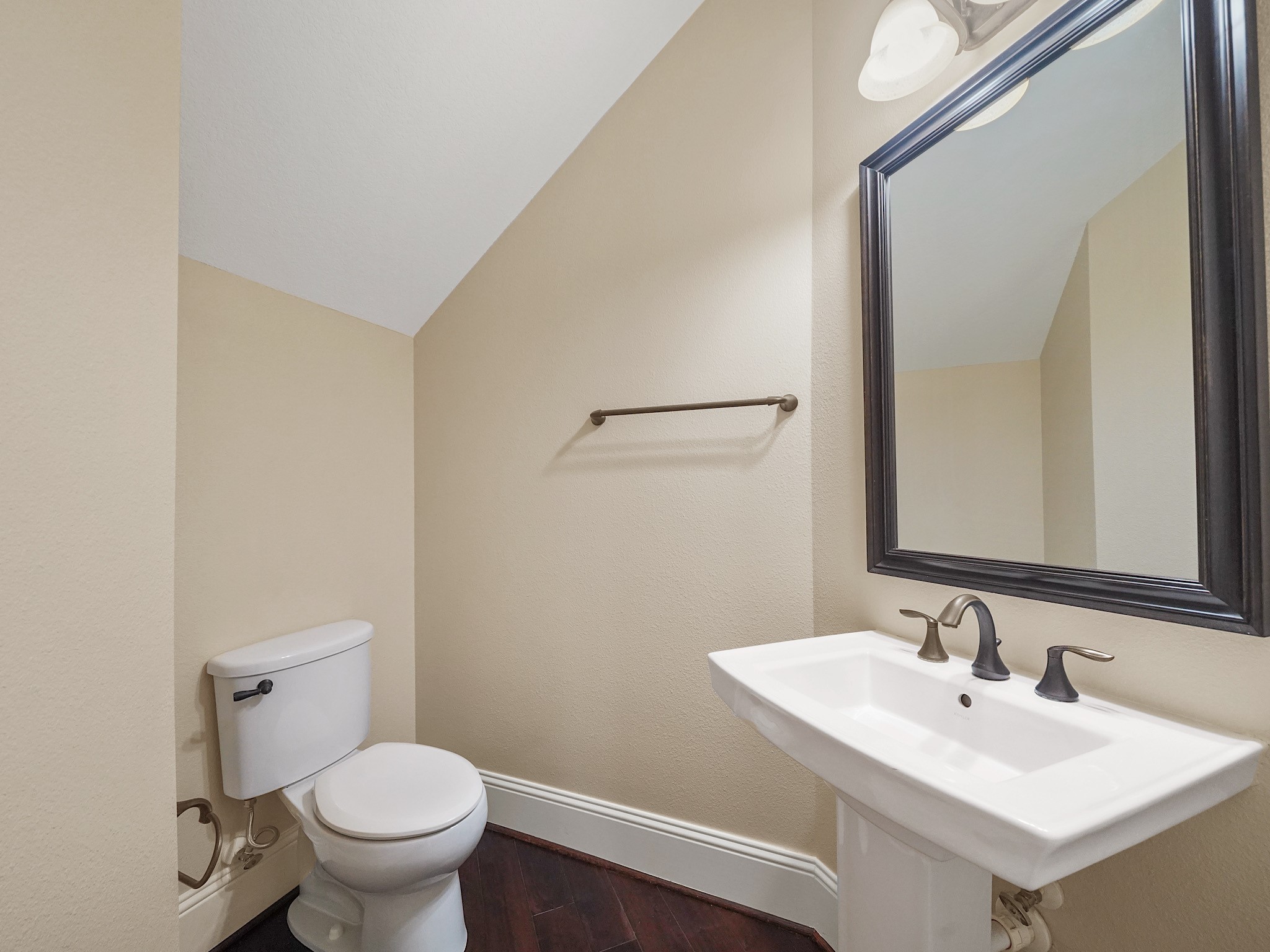 A tucked-away powder room adds thoughtful convenience on the first floor.