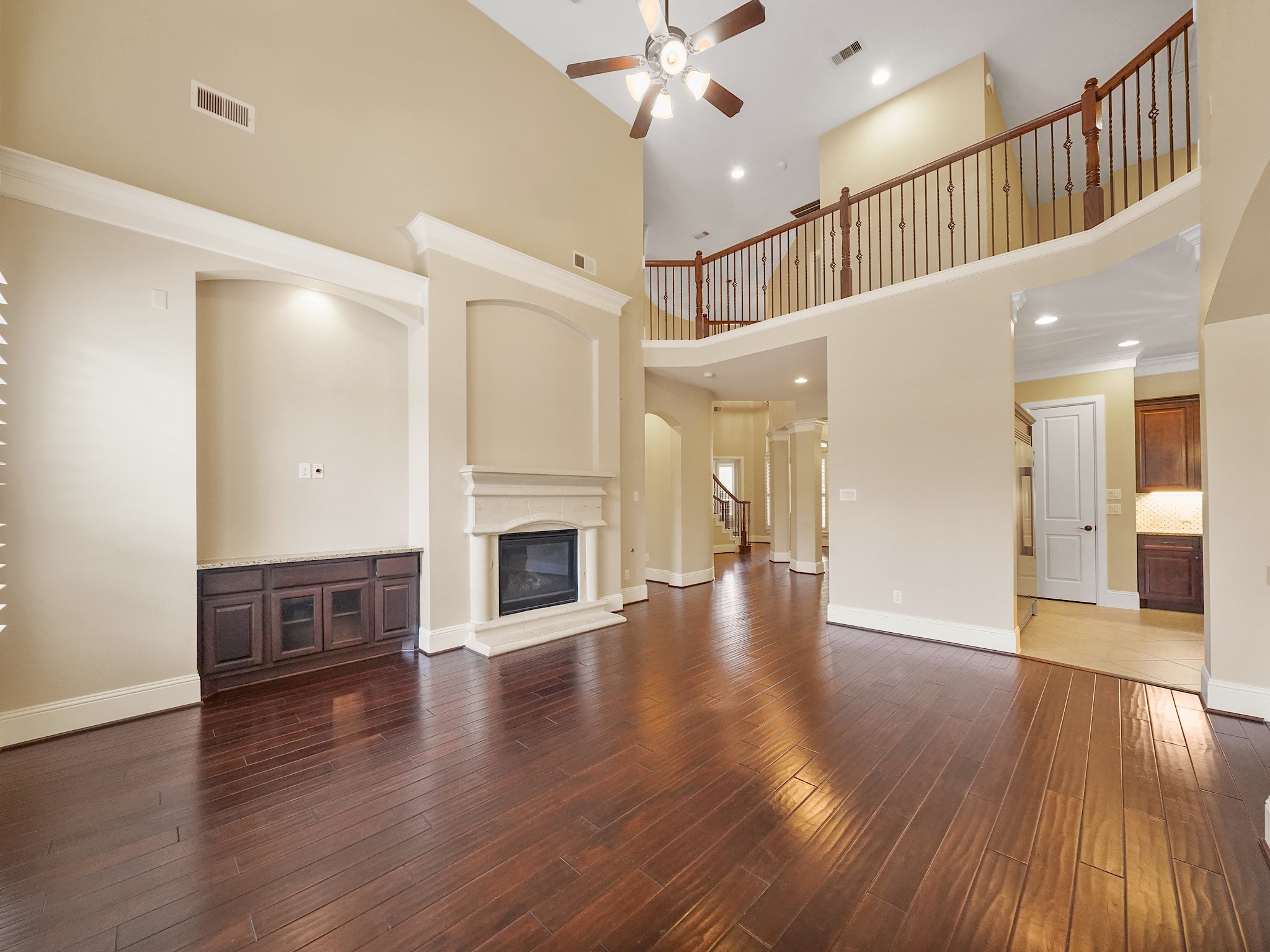 Look up to appreciate the two-story ceiling and open upstairs galleryarchitectural details that give the room an unmistakably grand feel.