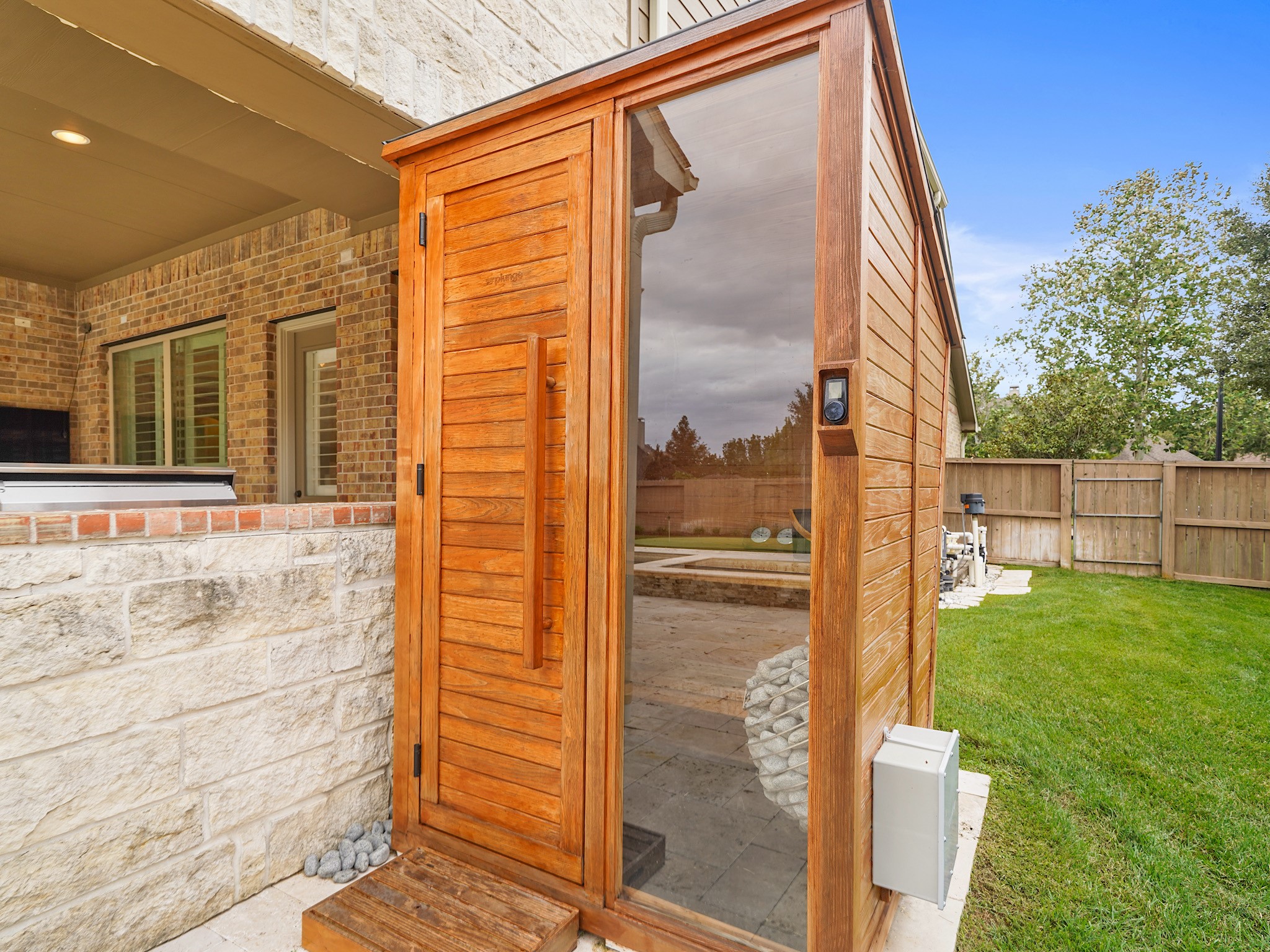 A cedar sauna adds a rare wellness amenity to the homes already exceptional outdoor setting.