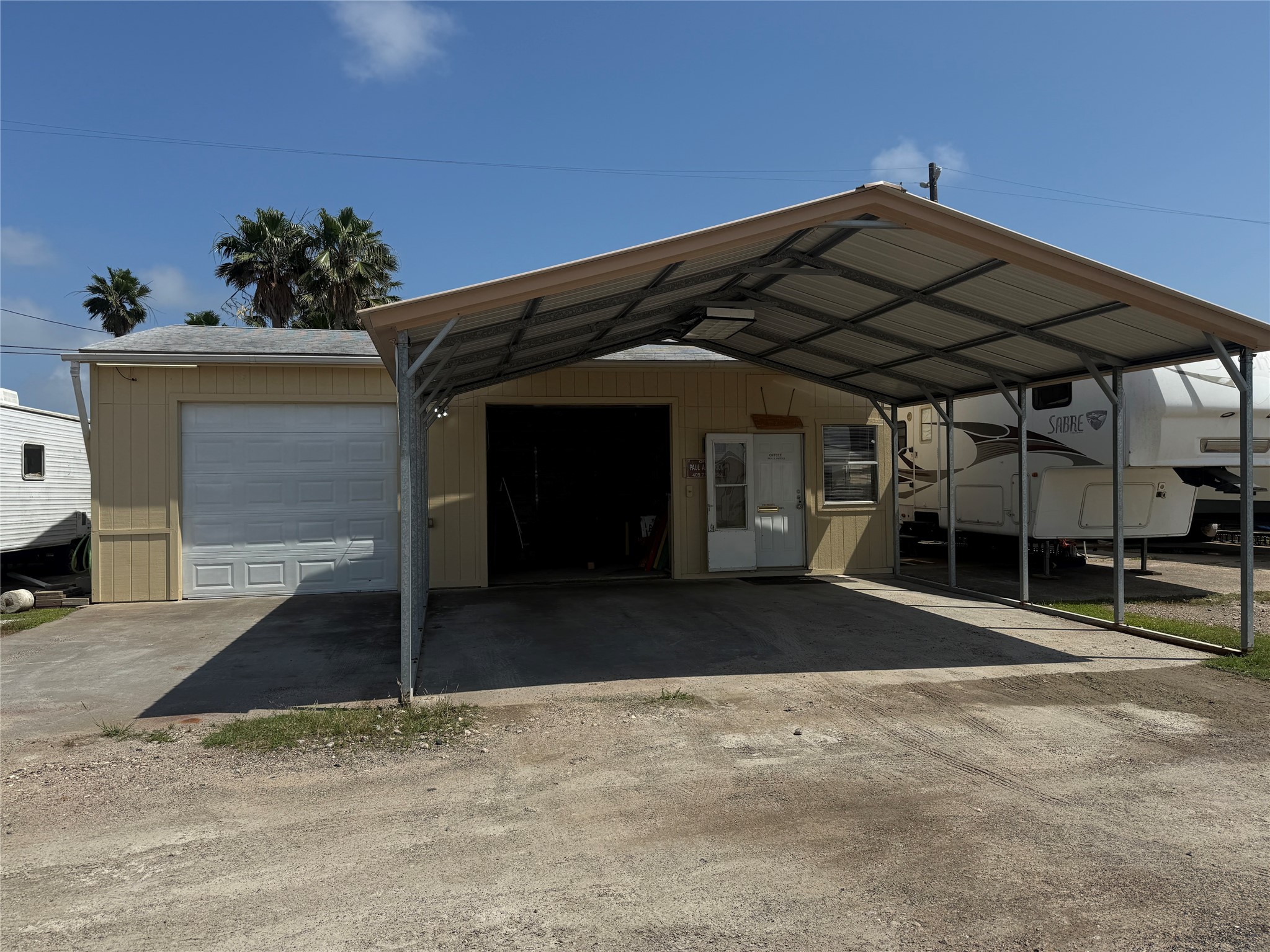 The 864 sq ft building with covered parking.