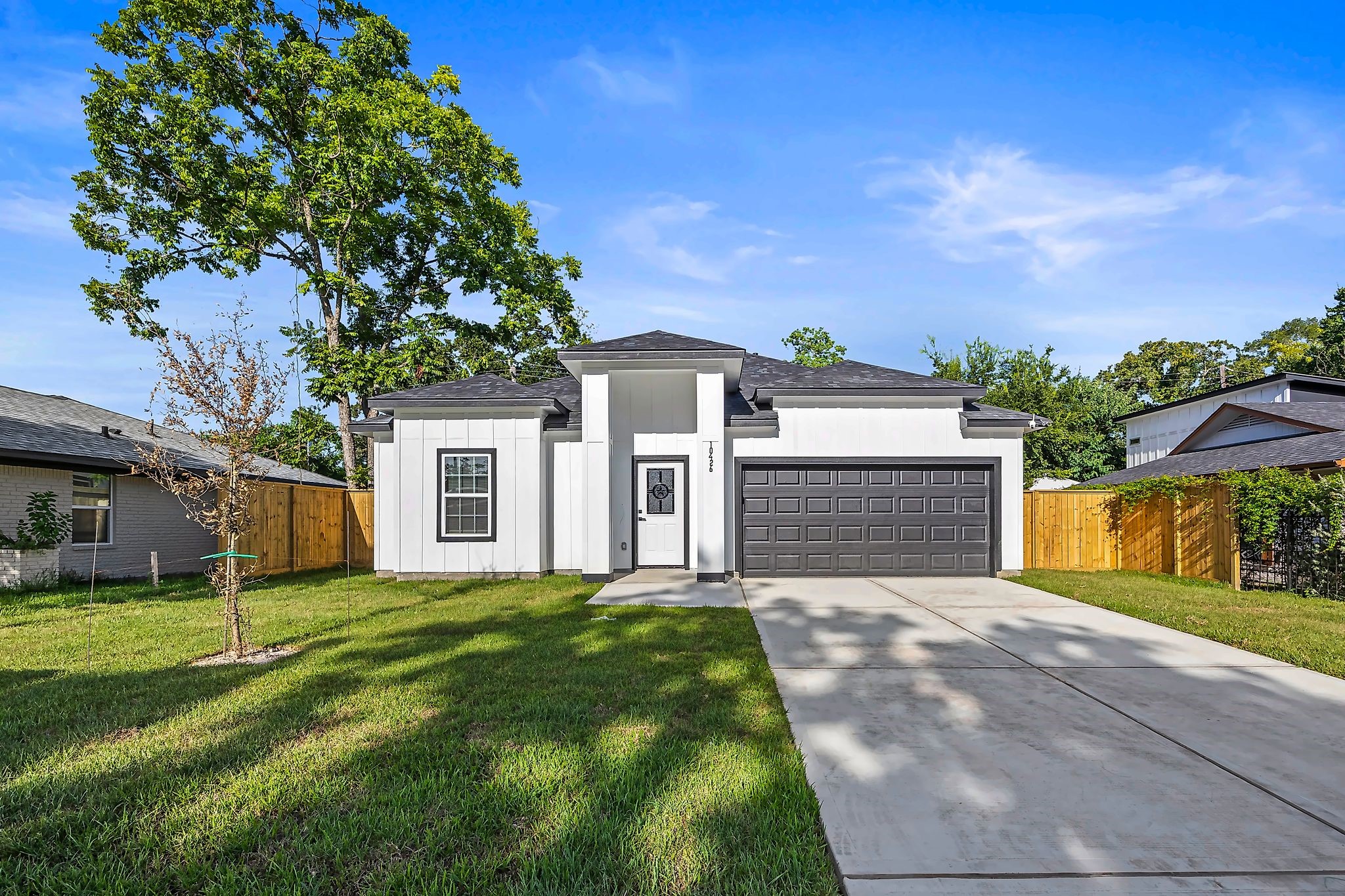 Charming modern home with a sleek facade, attached two-car garage, and a spacious front yard, nestled in a serene neighborhood. Charming modern home with a sleek facade, attached two-car garage, and a spacious front yard, nestled in a serene neighborhood.