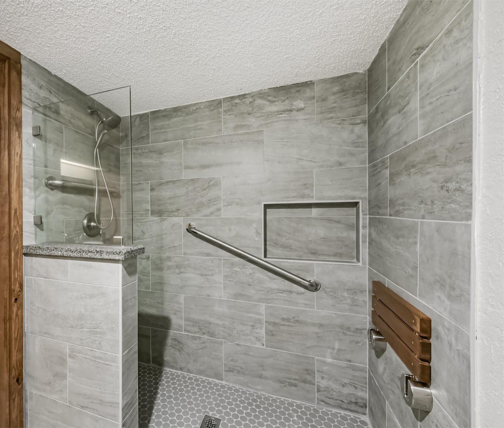 The walk-in shower is level on the ground.  There is no step you must step over to get in.