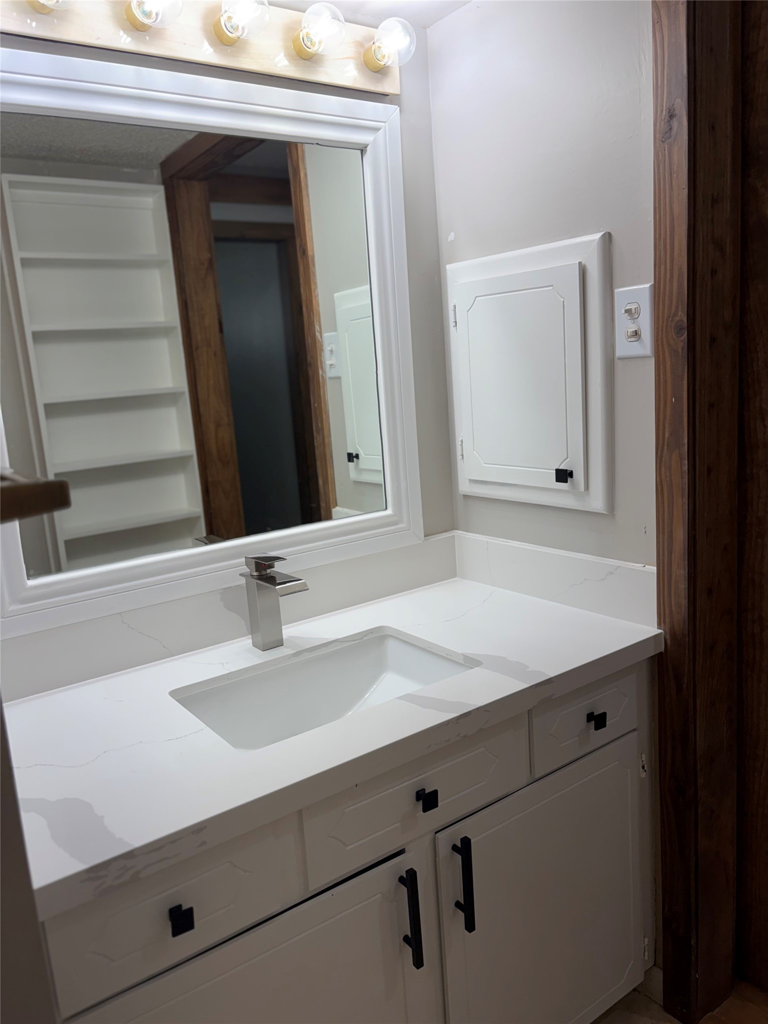You have extra storage in the hall bath with the shelves and medicine cabinet.