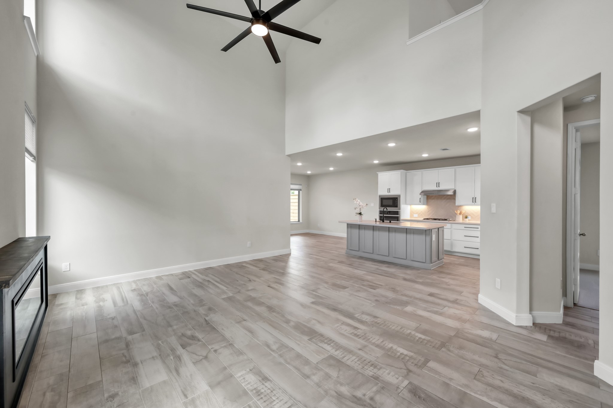 Spacious open-concept living area with soaring ceilings and seamless flow into the kitchen.