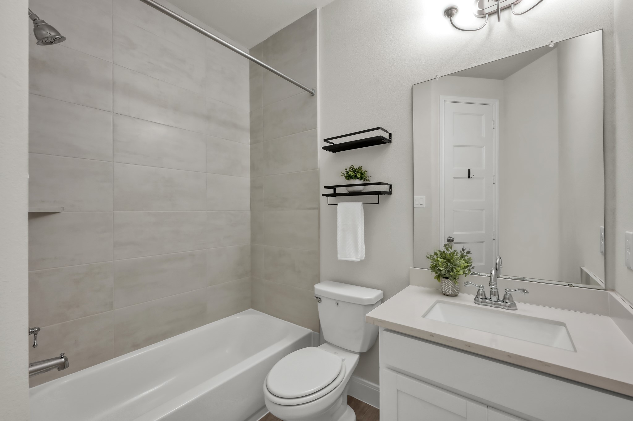 Full secondary bath with tub/shower combo and clean, modern finishes.
