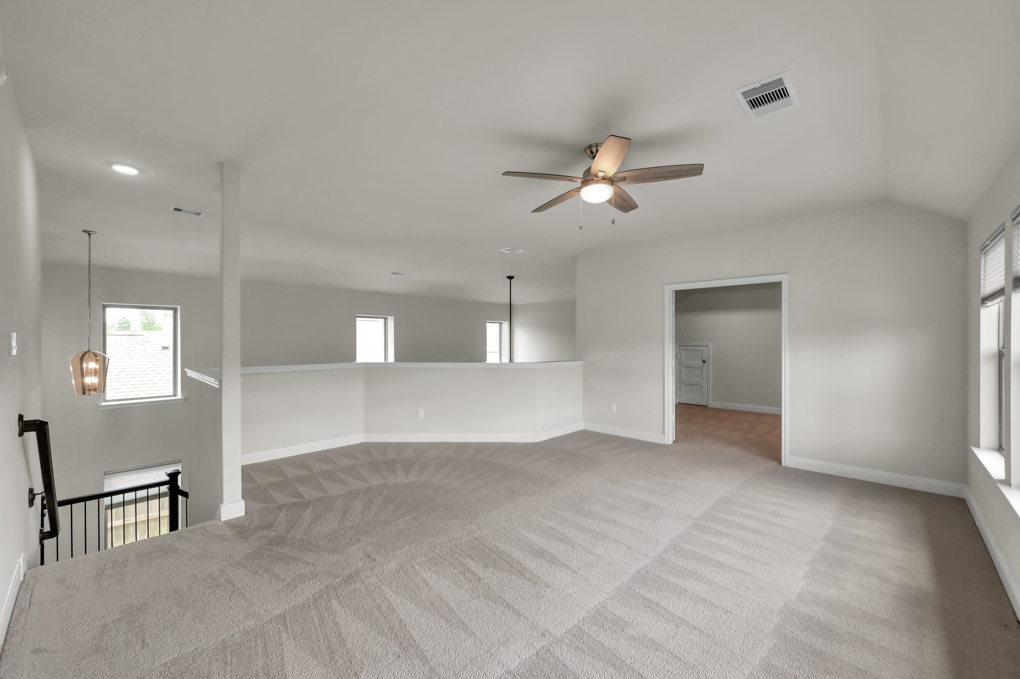 Upstairs game room with connected media room  ideal for movie nights, gaming, and family entertainment.