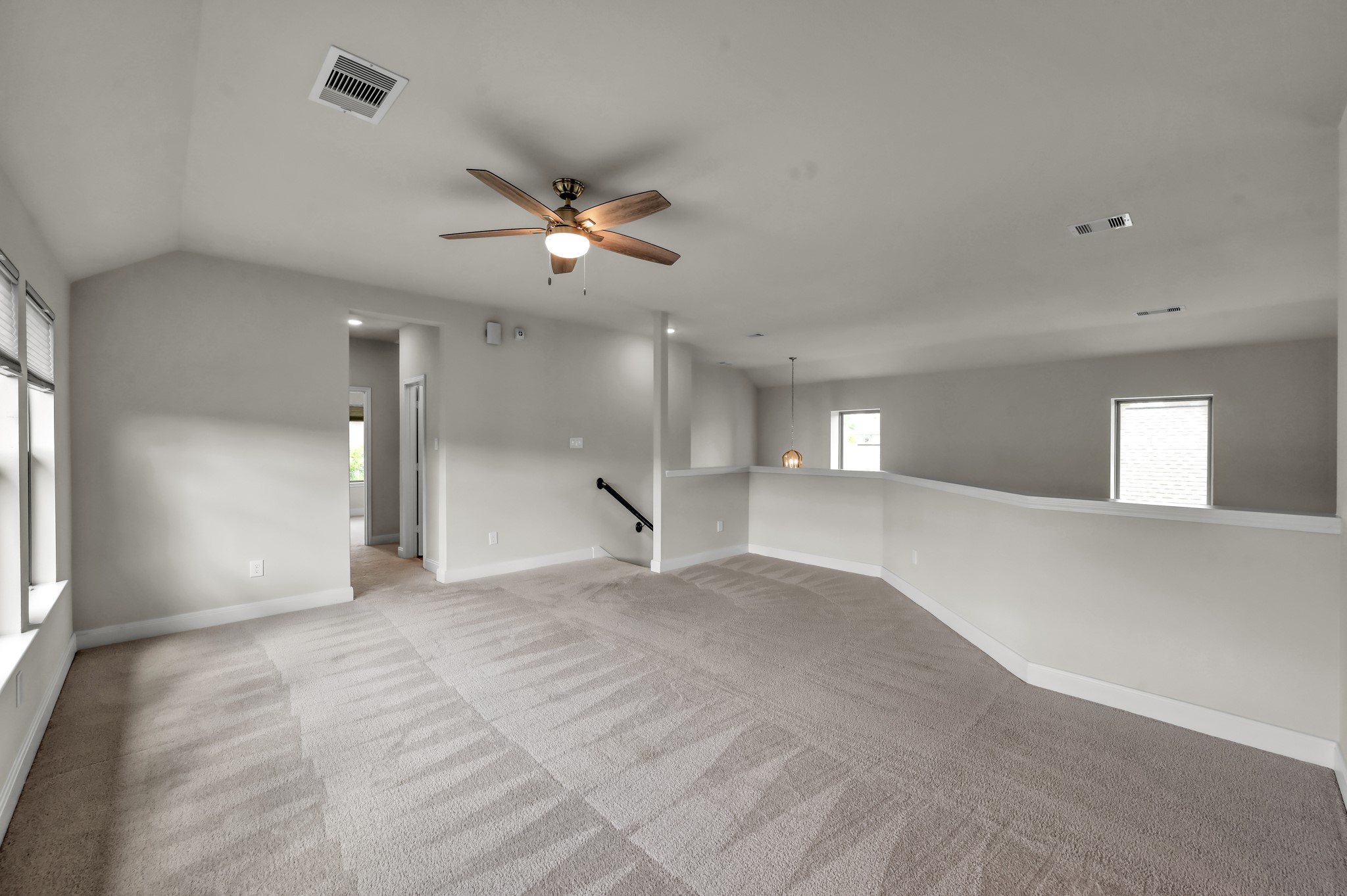 Additional view of the spacious upstairs game room, offering plenty of room for relaxing, play, and entertaining.