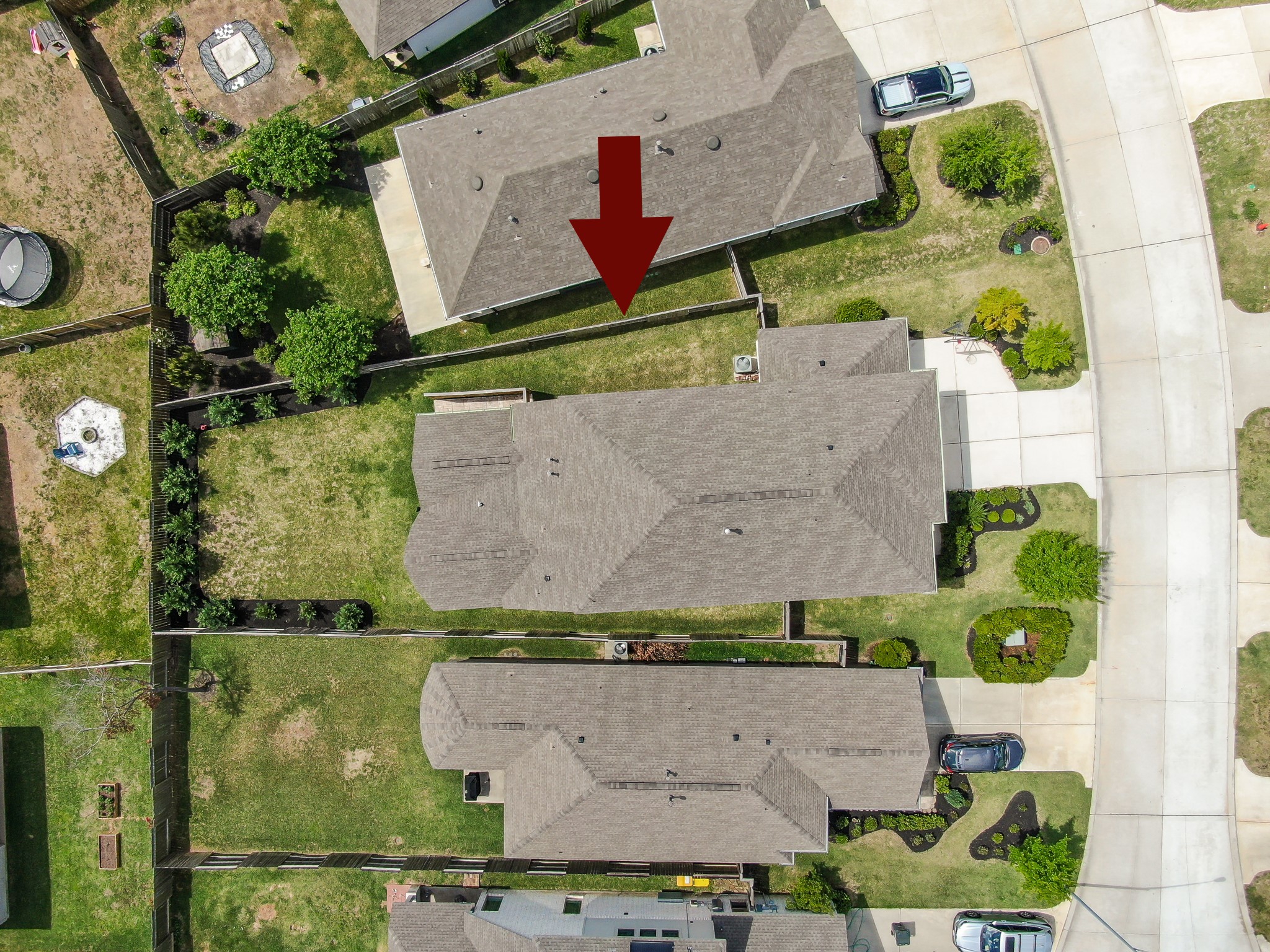 Aerial view showcasing the spacious lot, fenced backyard, and covered patio.