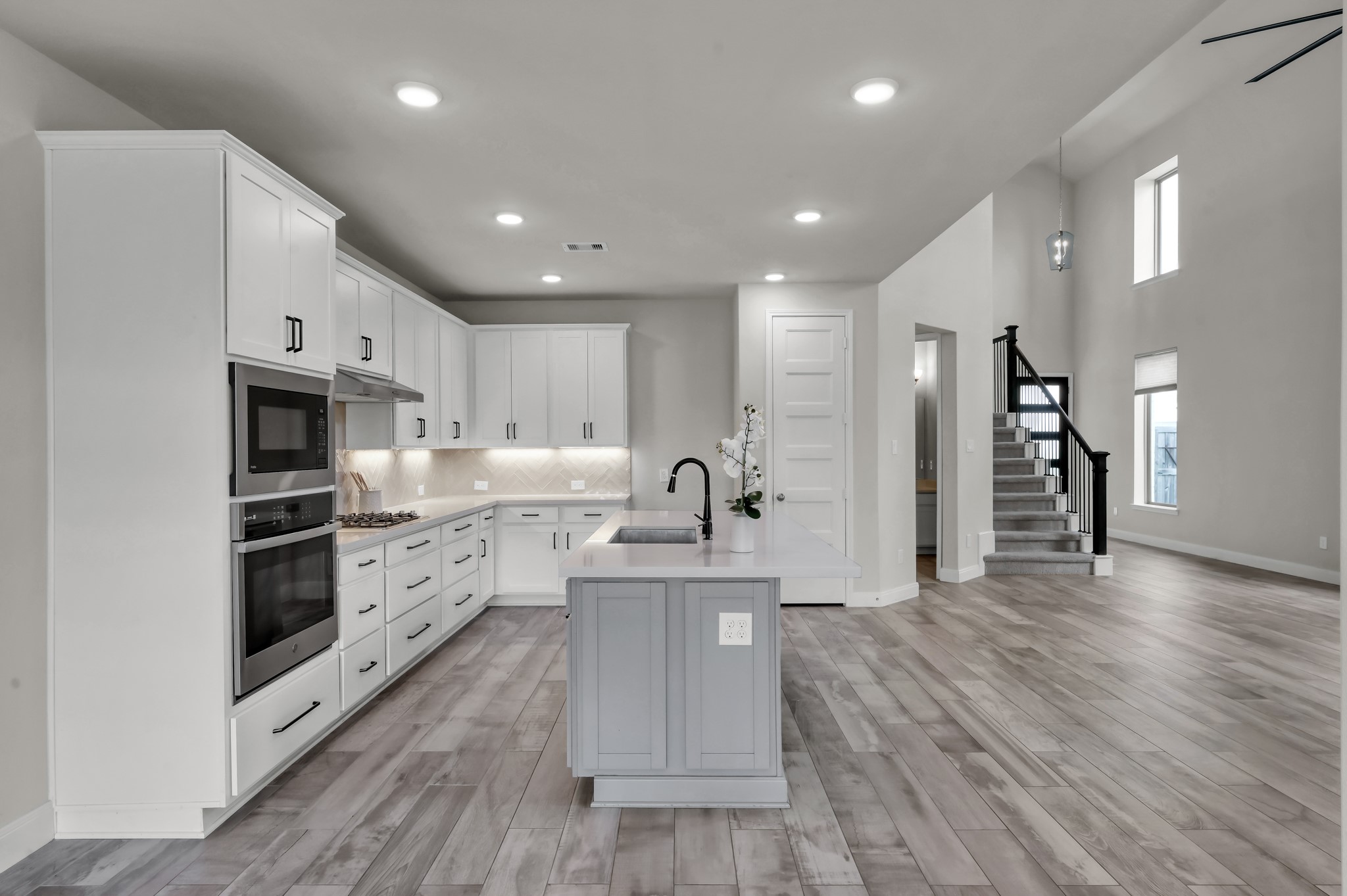 Open-concept kitchen and living space with modern finishes throughout.