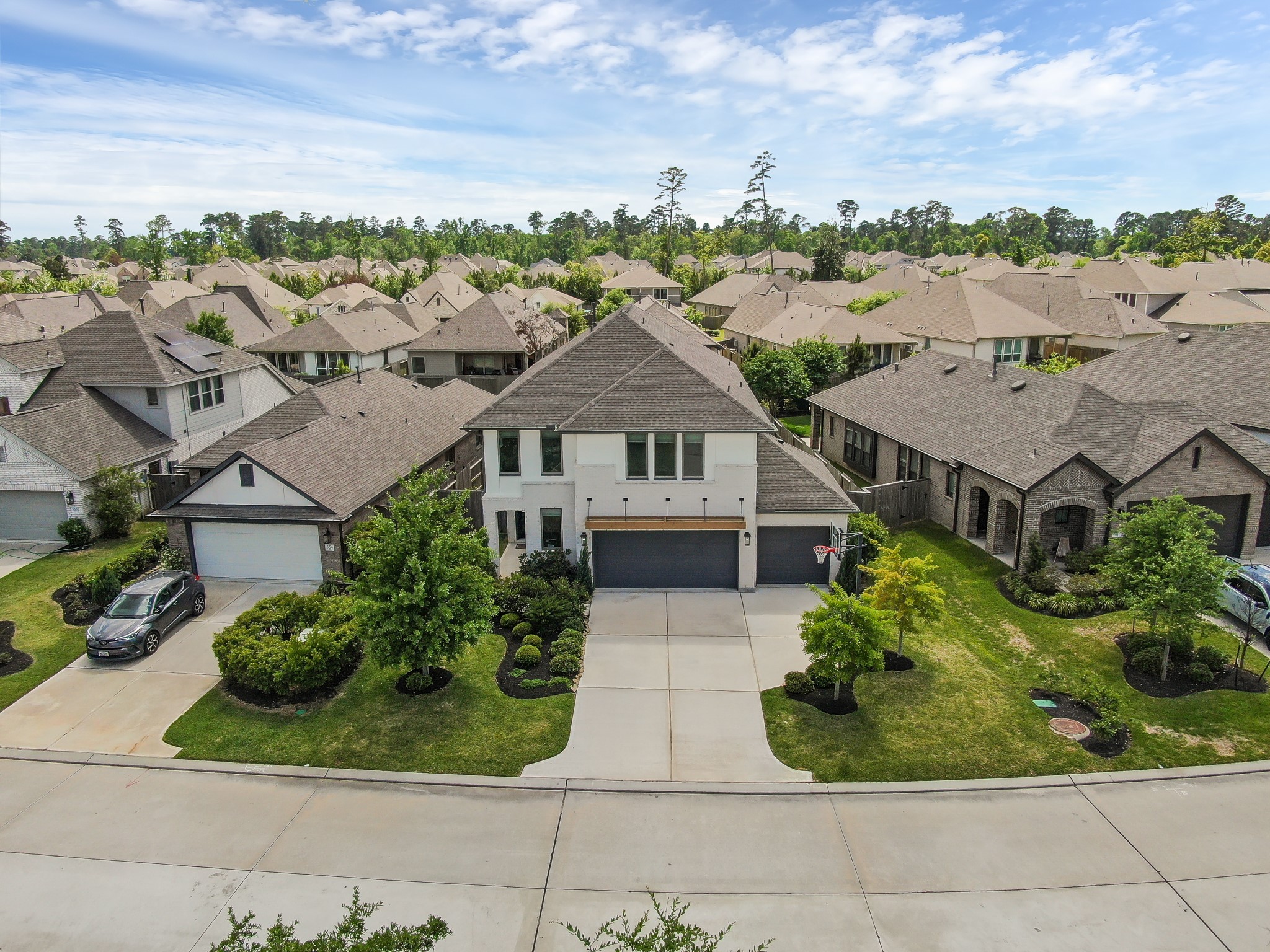 Aerial view showcasing lush landscaping and well-maintained surrounding homes. Aerial view showcasing lush landscaping and well-maintained surrounding homes.