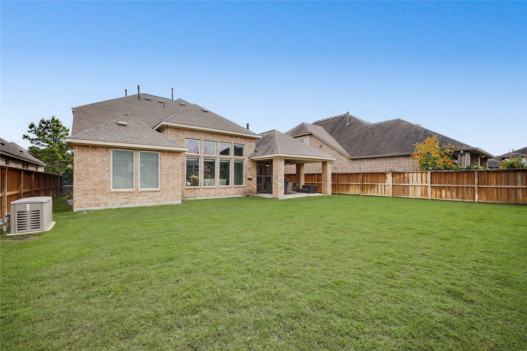 Spacious backyard with green lawn and room for outdoor living.