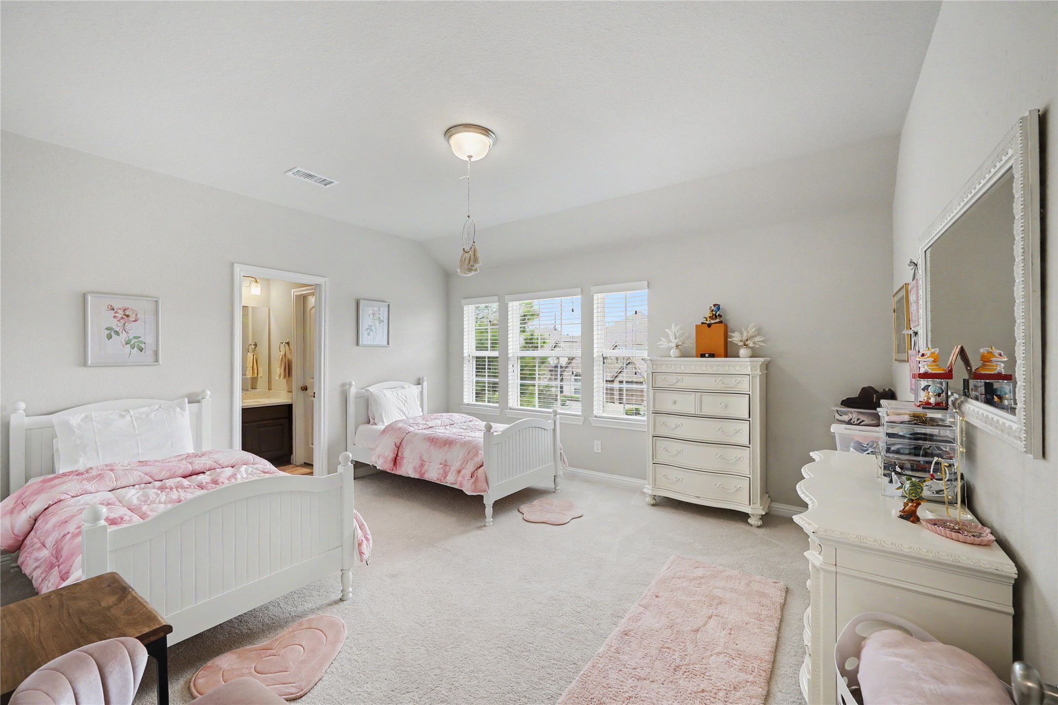 Secondary bedroom with neutral finishes, ceiling fan, and multiple windows.