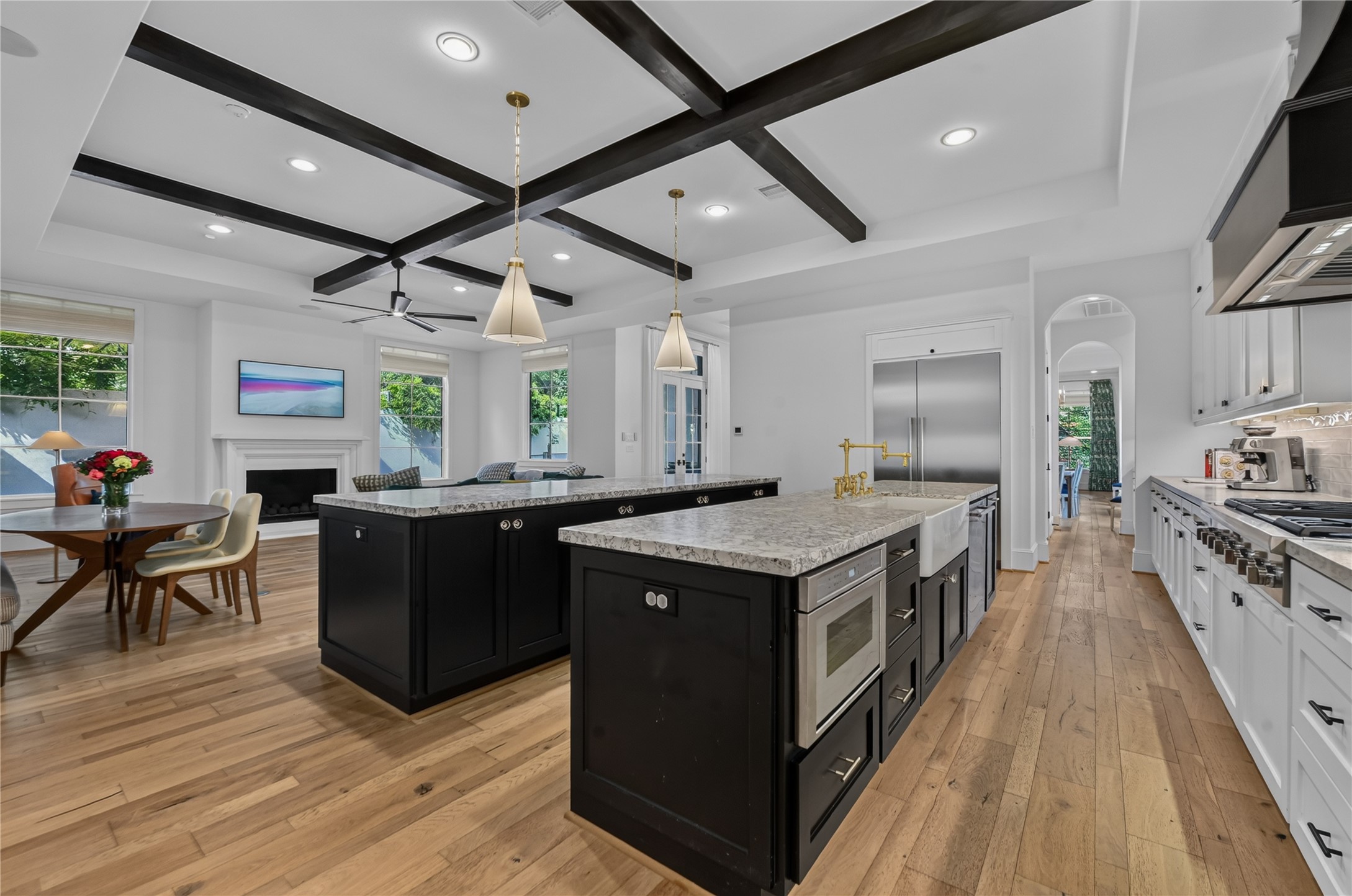 Past your staircase, you are greeted into this massive kitchen with double island, breakfast area & family room