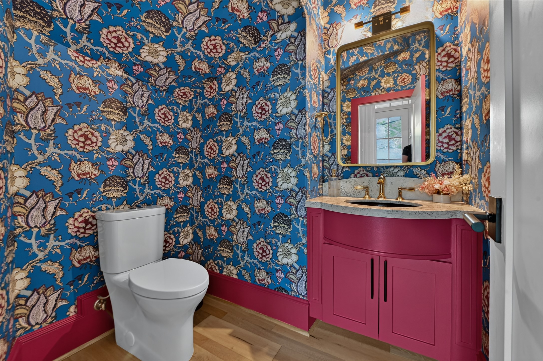 Powder bath with custom wall paper is a great statement piece for guests.