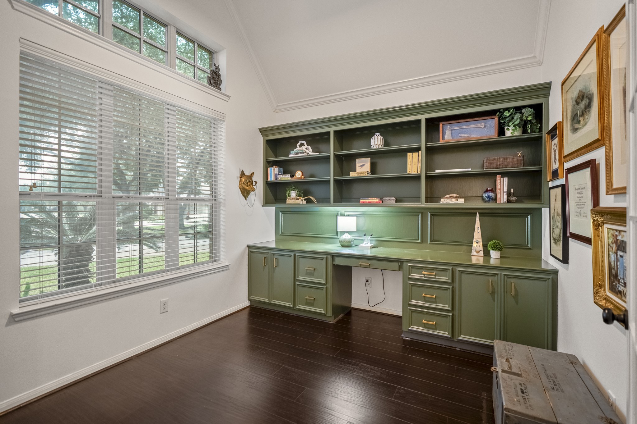 The home office / study offers plenty of natural light with large windows, you have the ease of the custom built in desk and shelves for your convenience.