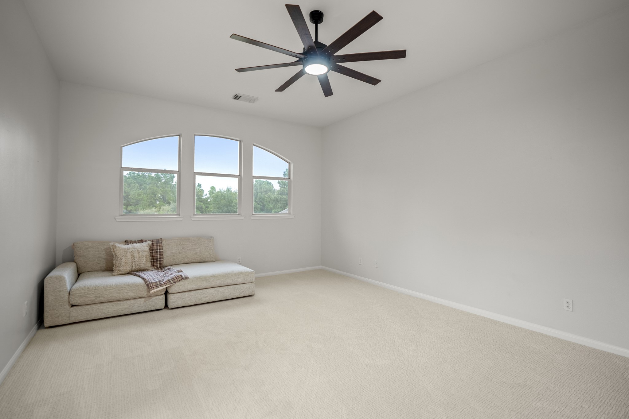 Upstairs you have this huge game room, which has plenty of space for multiple gaming area as well as a nice size trio of windows and large modern ceiling fans.