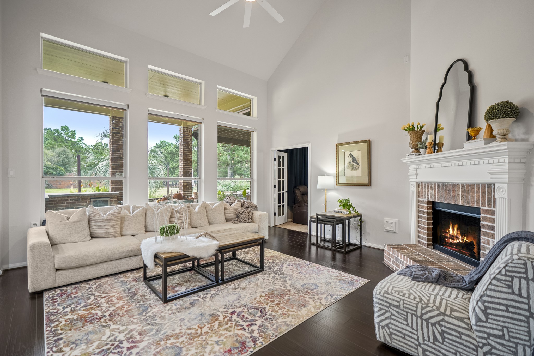 Boasting soaring cathedral ceilings and a dramatic wall of windows, this space offers beautiful views of the backyard and golf course, while flooding the home with brilliant natural light.