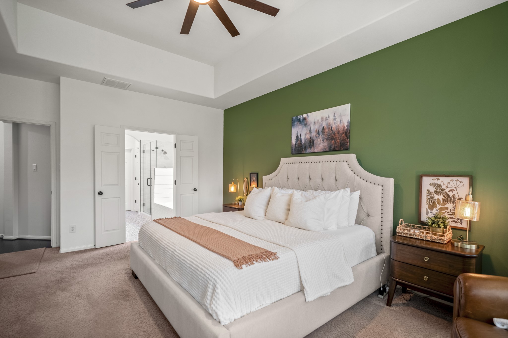 The primary bedroom is large enough for a king size bedroom set. Double doors lead to the en-suite bathroom.