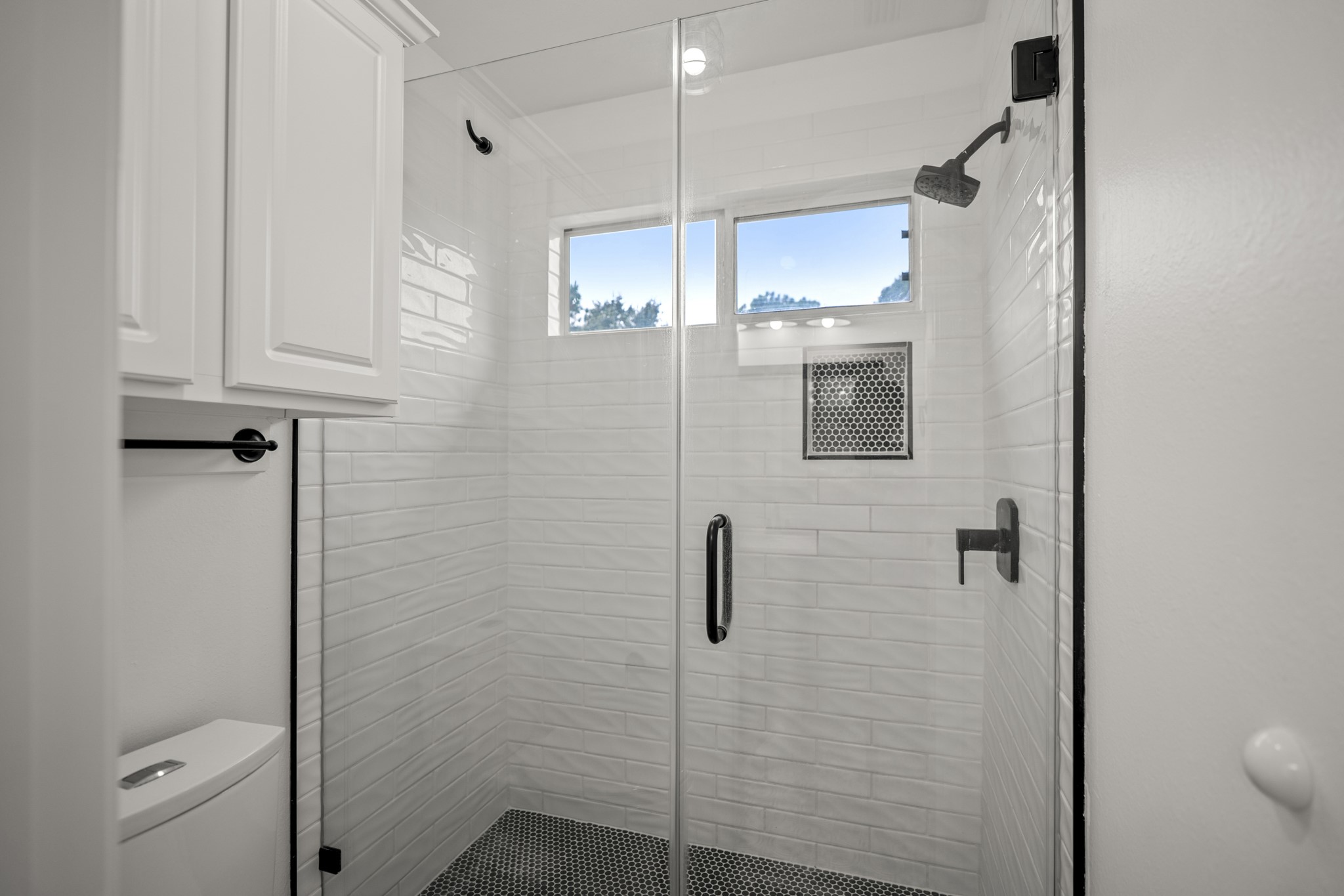 The upstairs bathroom has a fully glass enclosed shower and has been updated to be modern in design.
