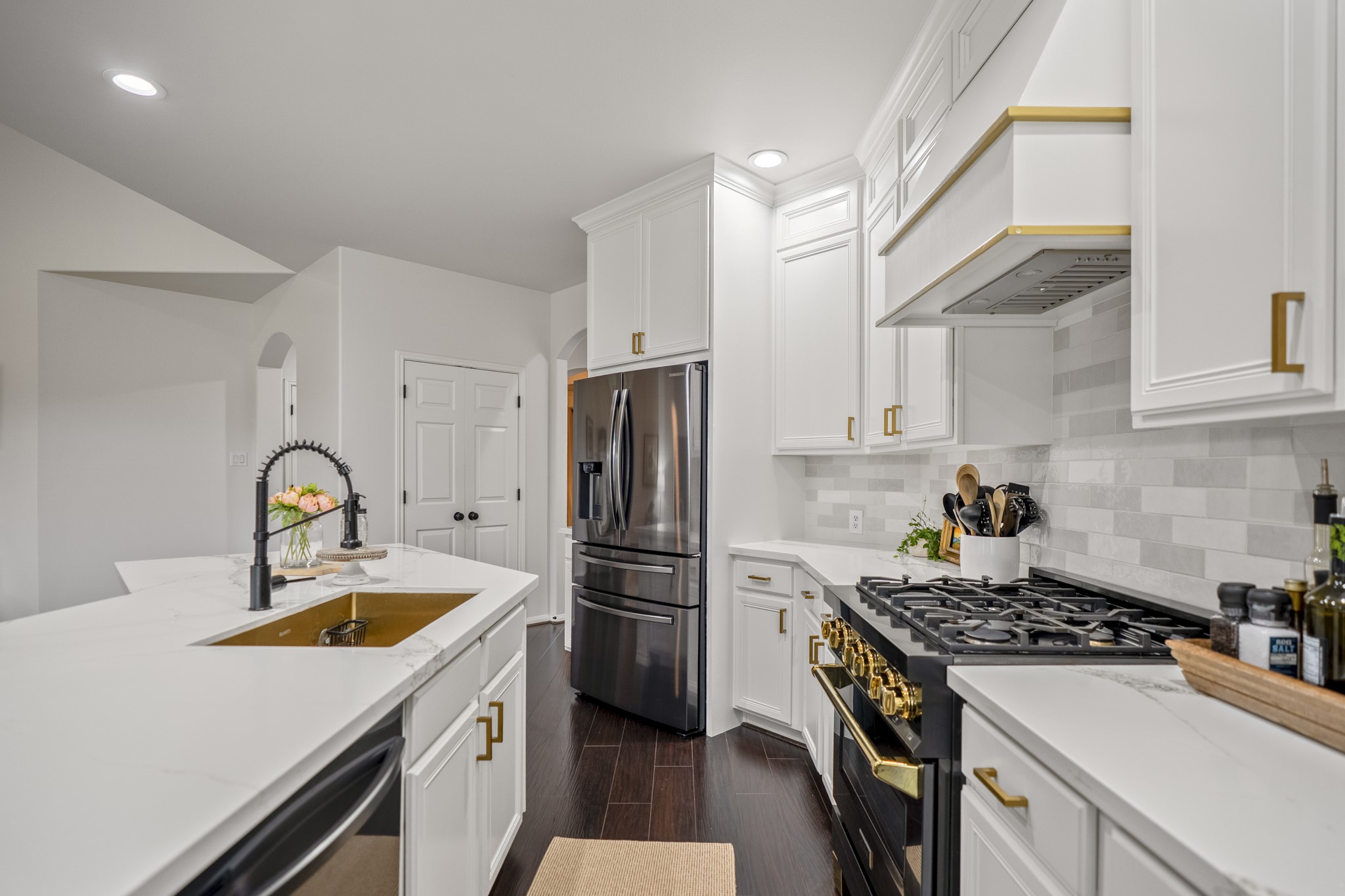 The kitchen has been updated and features quartz countertops, a ZLINE four-burner gas range, double ovens & wine fridge.