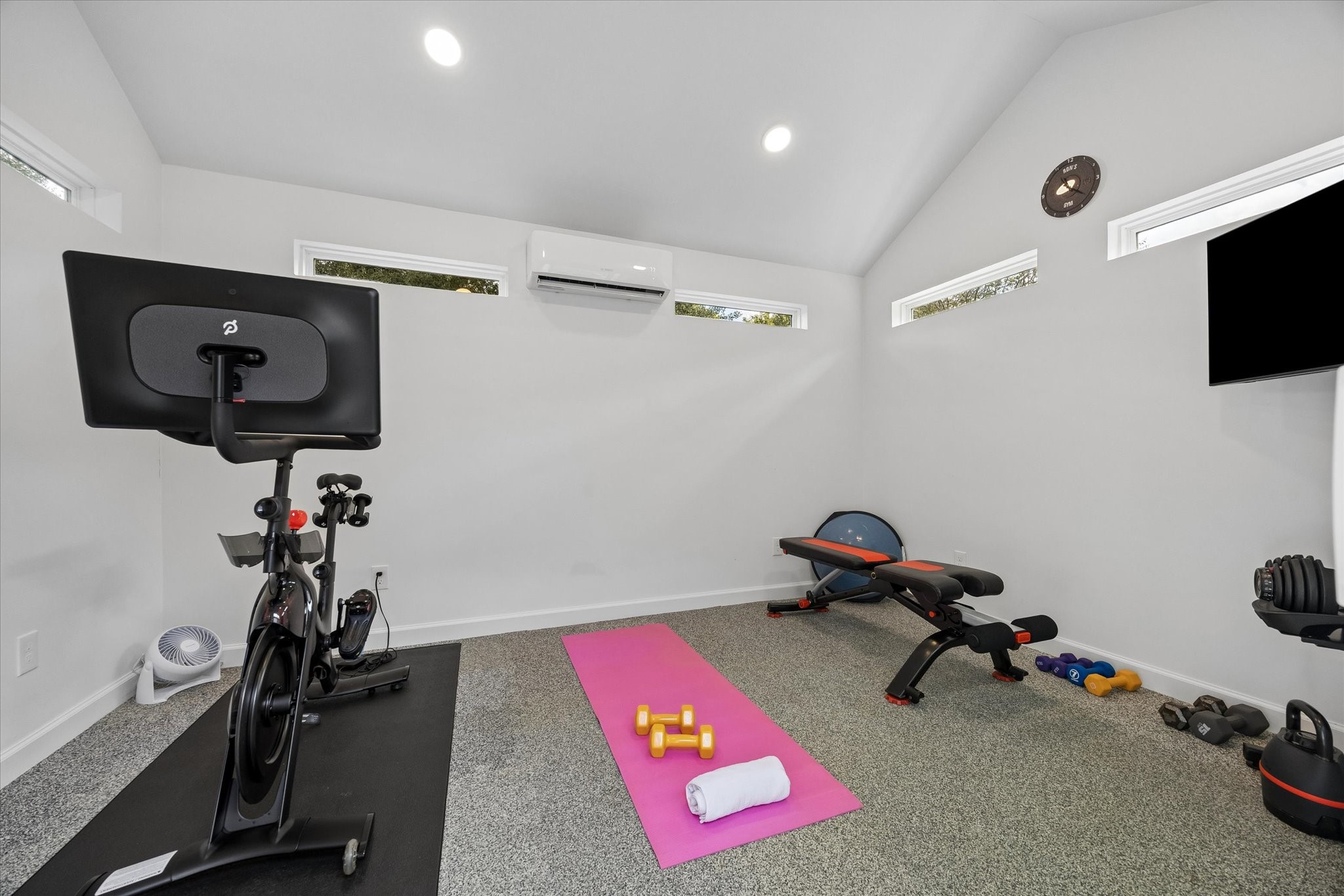 GYM: Custom-built fitness studio features high windows, durable flooring and a dedicated mini-split system for year-round comfort. This space would also make a great art studio or additional office area.
