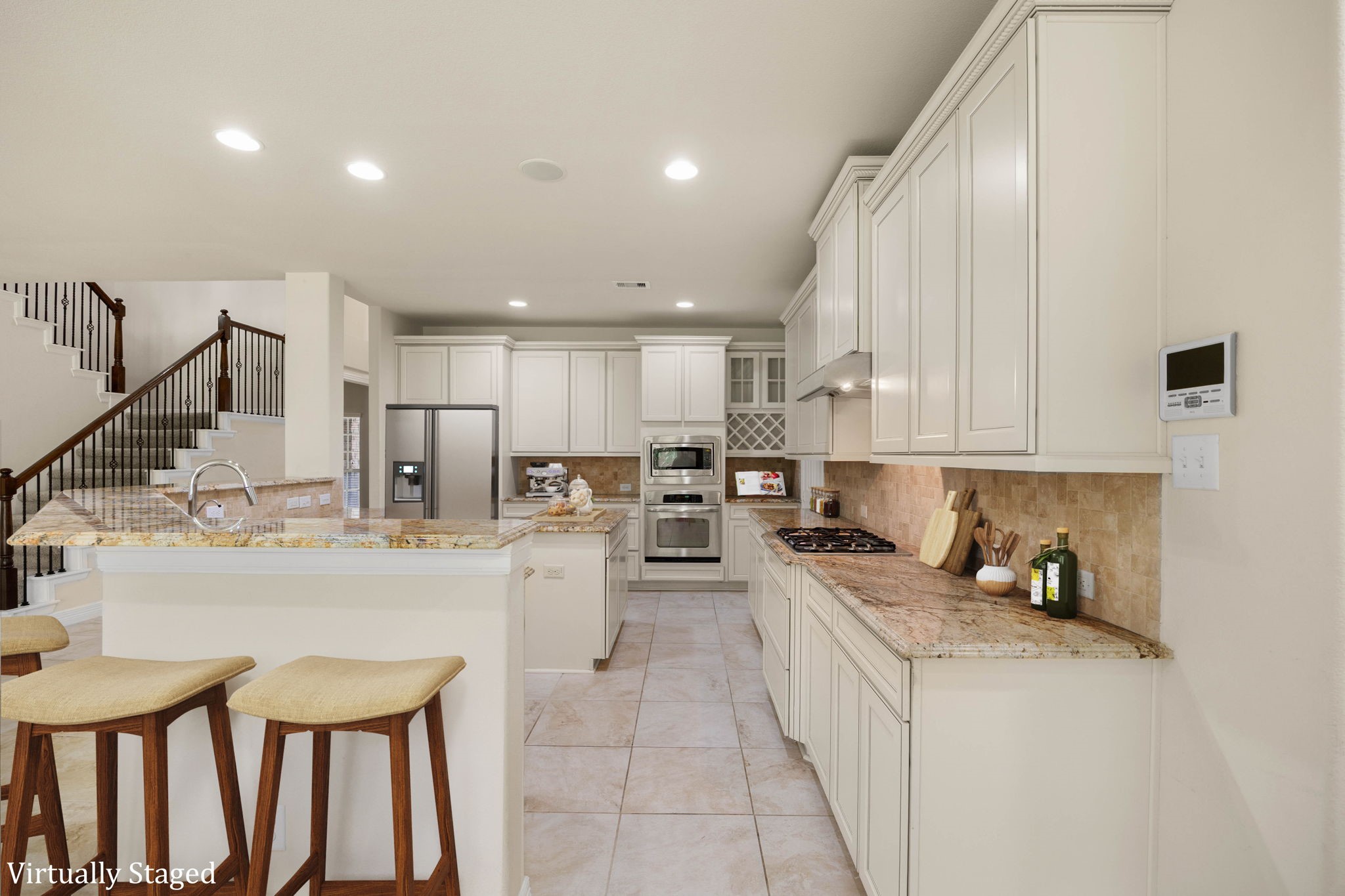 Large, open kitchen with walk-in pantry and an island with storage, abundant cabinetry, granite countertops, recessed lighting, built-in appliances, wine rack, and generous counter space for meal preparation and entertaining.
