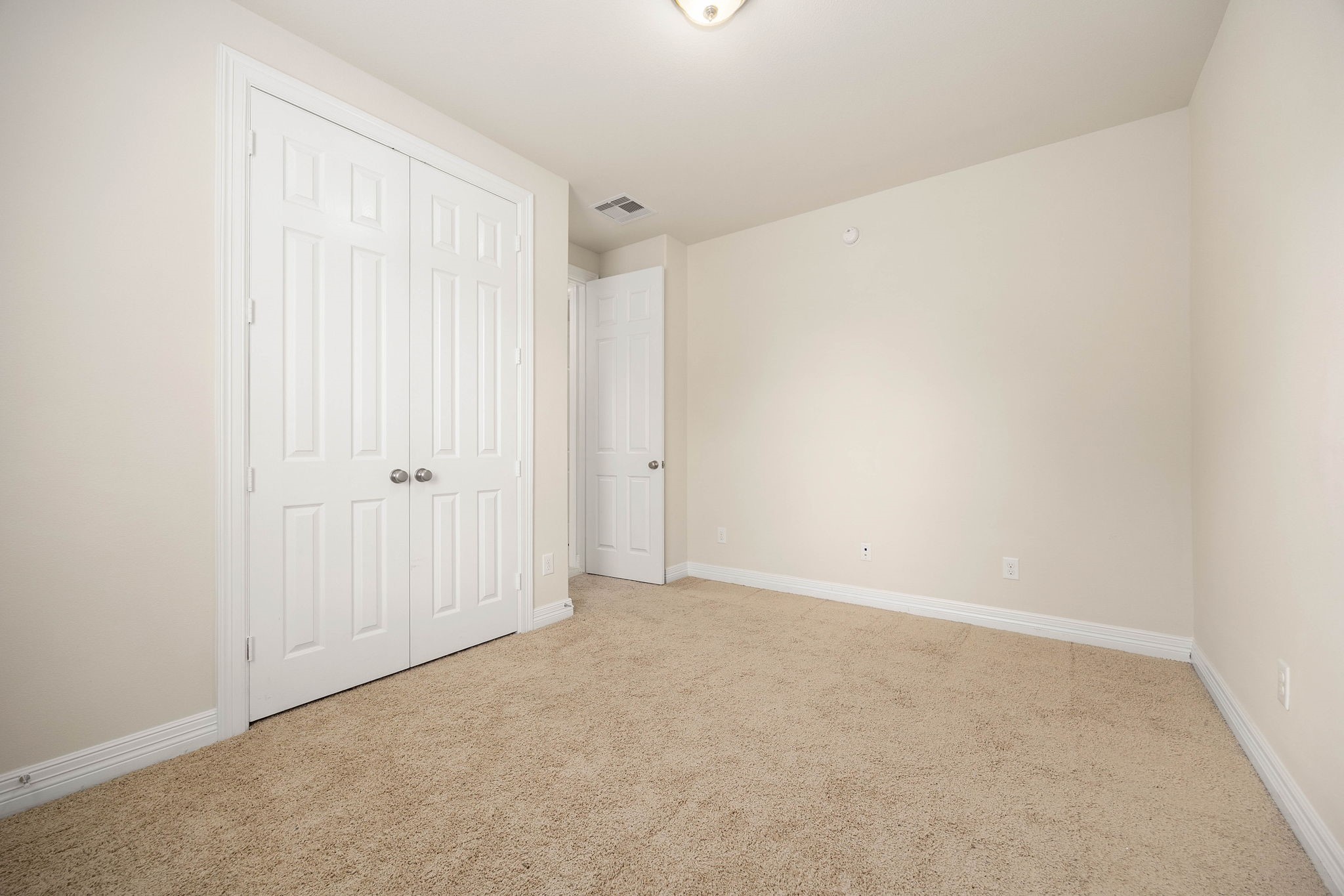 First floor secondary bedroom features a double-door closet.