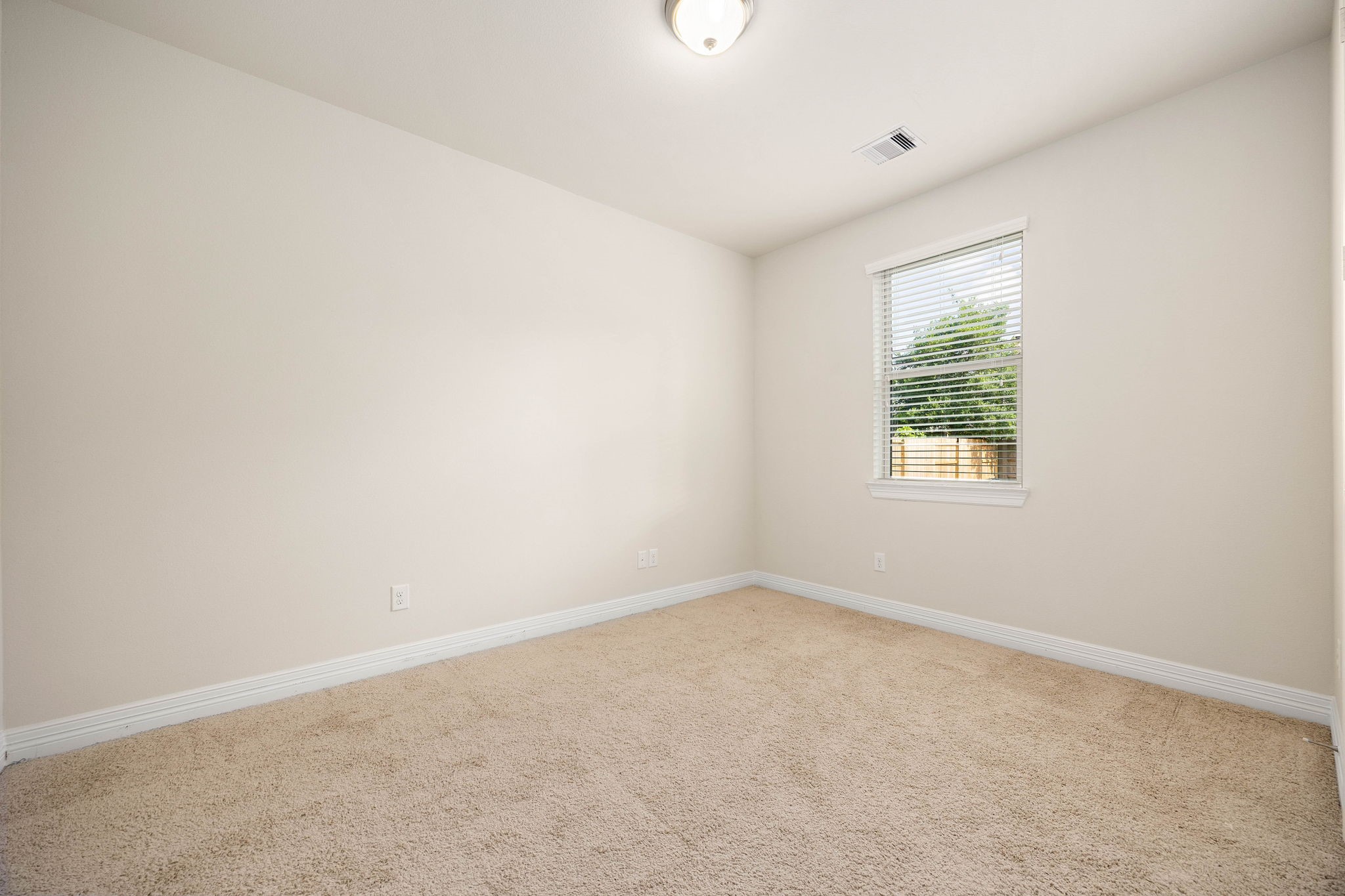 First floor secondary bedroom is perfect for guests, multi-generational living, or as a flex room with a double door closet.