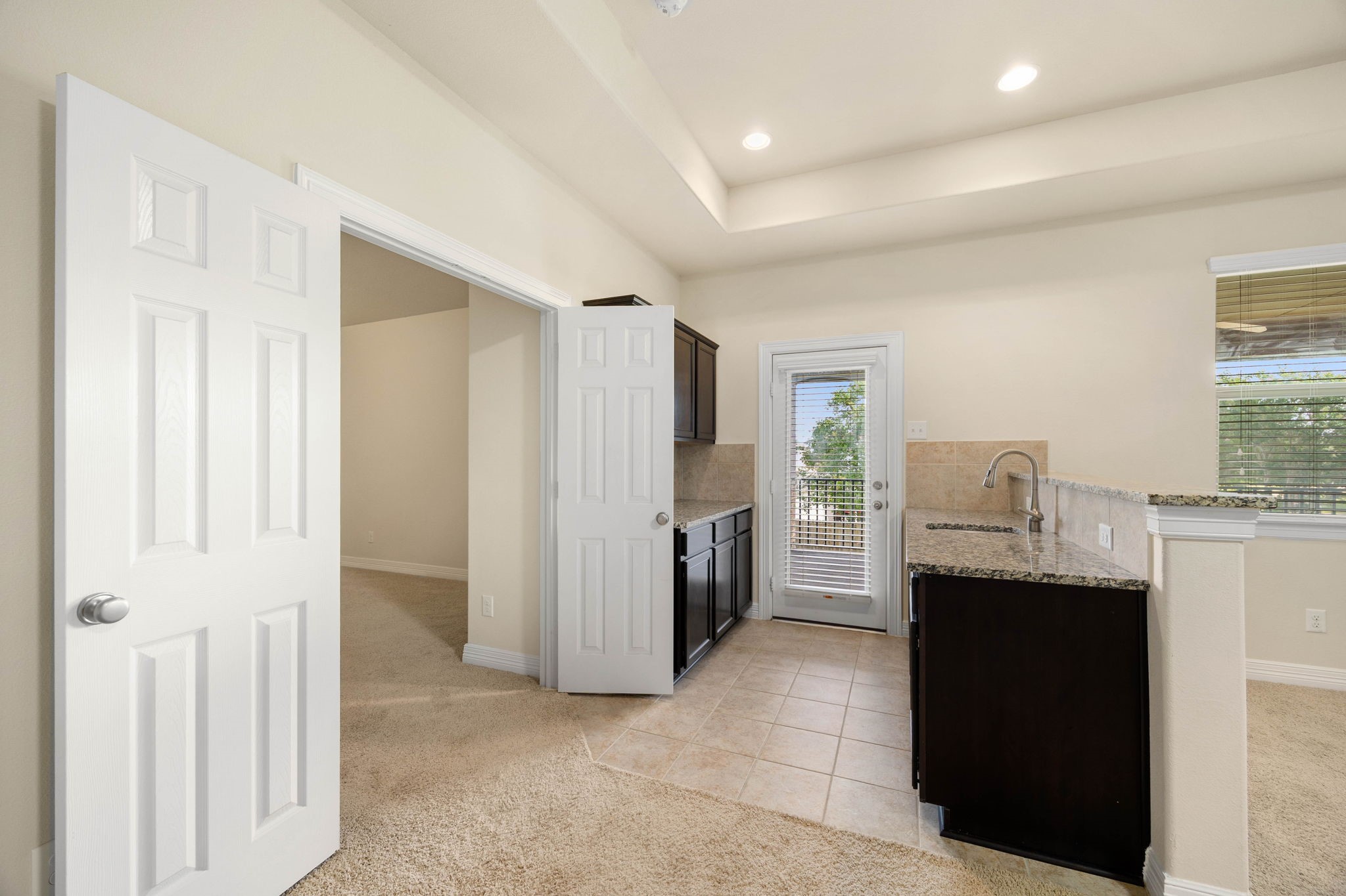 Entertain with ease from the convenient upstairs kitchenette featuring ample cabinetry, counter space, and a sinkperfectly positioned to serve the game room, nearby media room, and outdoor covered deck area.