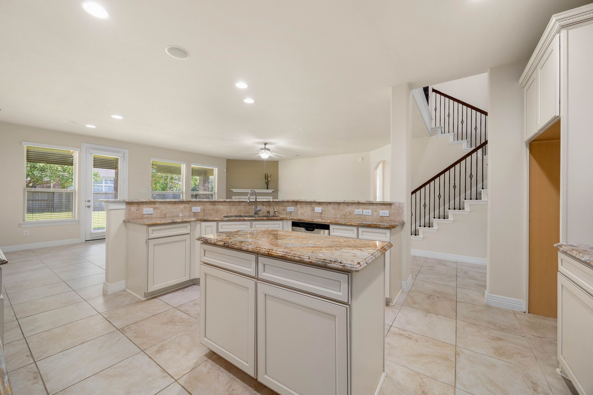 The spacious kitchen overlooks the breakfast and family areas, creating an easy flow between cooking, dining, and entertaining spaces.