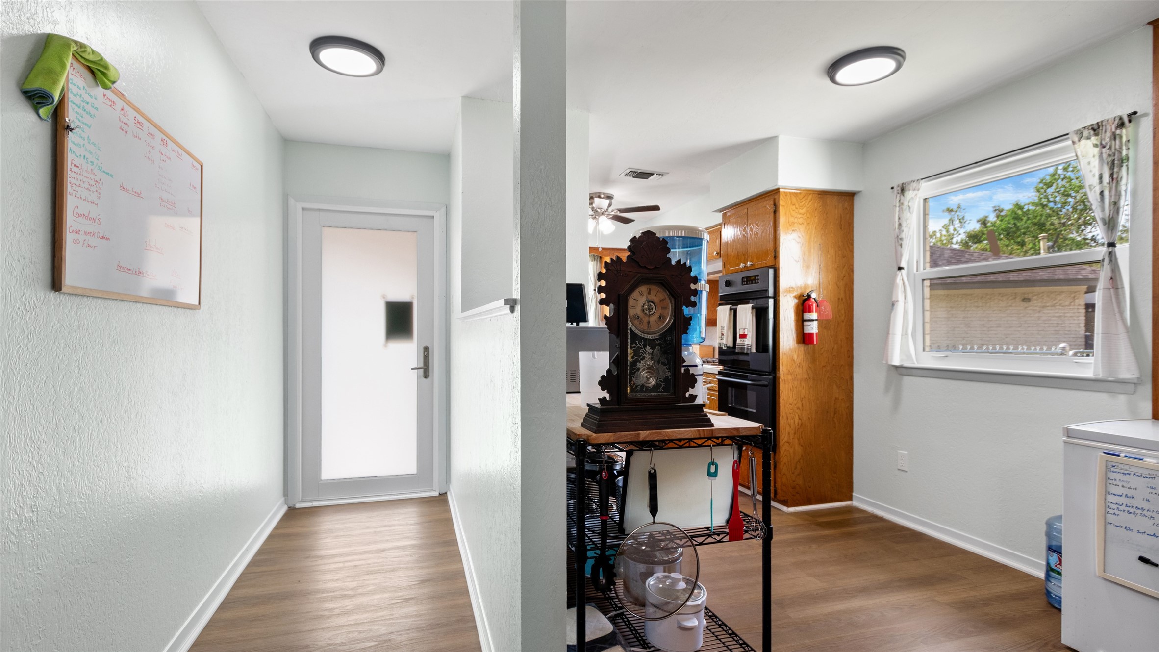 Flexible space just off the kitchen offers abundant natural light, wood-look flooring, and potential for a breakfast area, home office, or additional everyday living space.