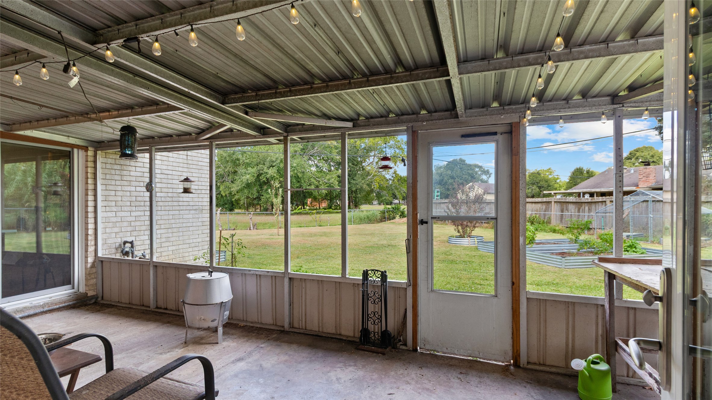 Expansive covered and screened patio extends the living space outdoors, offering a shaded spot to relax or entertain while overlooking the large backyard.