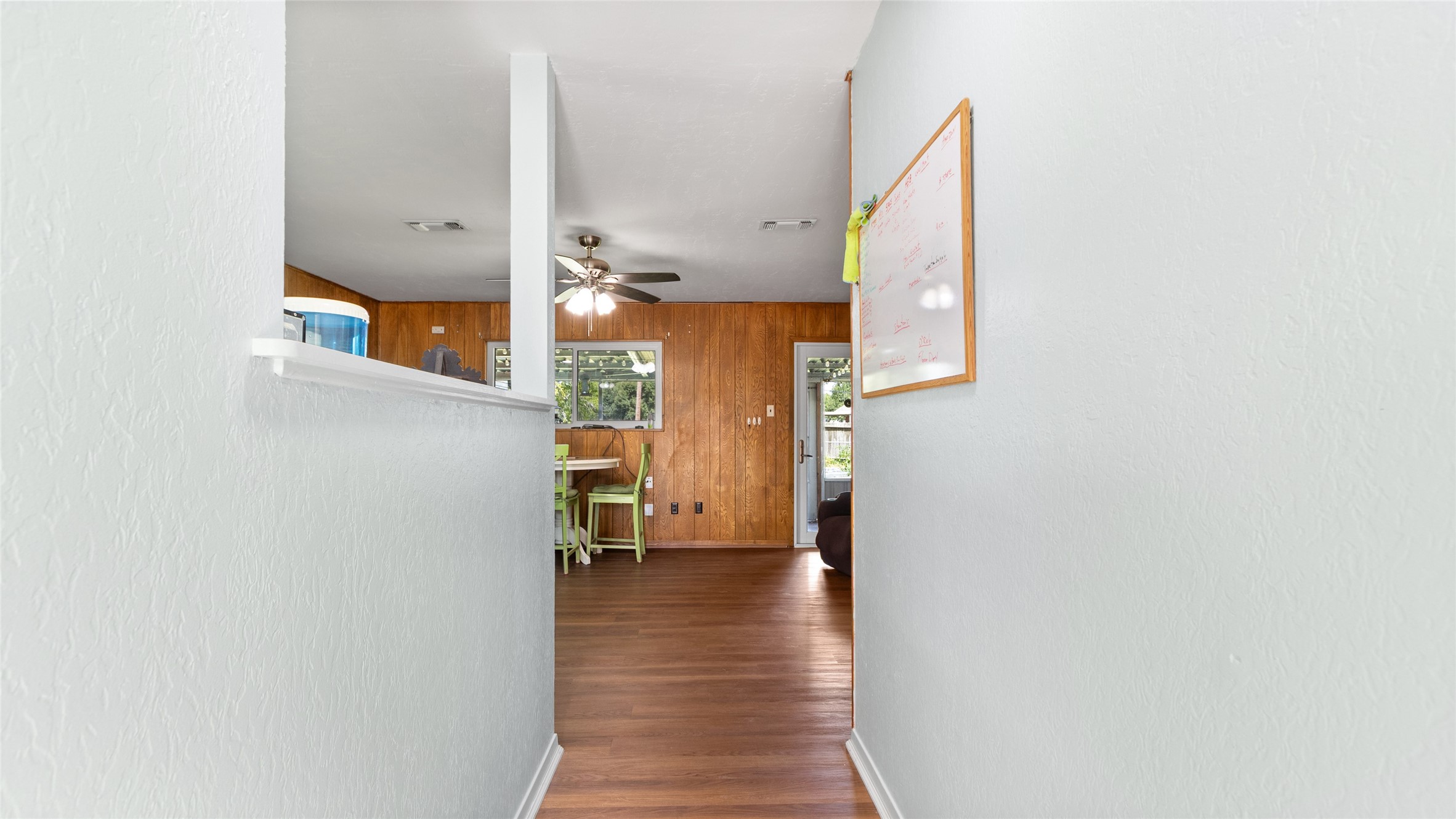 Welcoming entry opens into the main living areas, with wood-look flooring and a layout that provides an easy flow through the home.