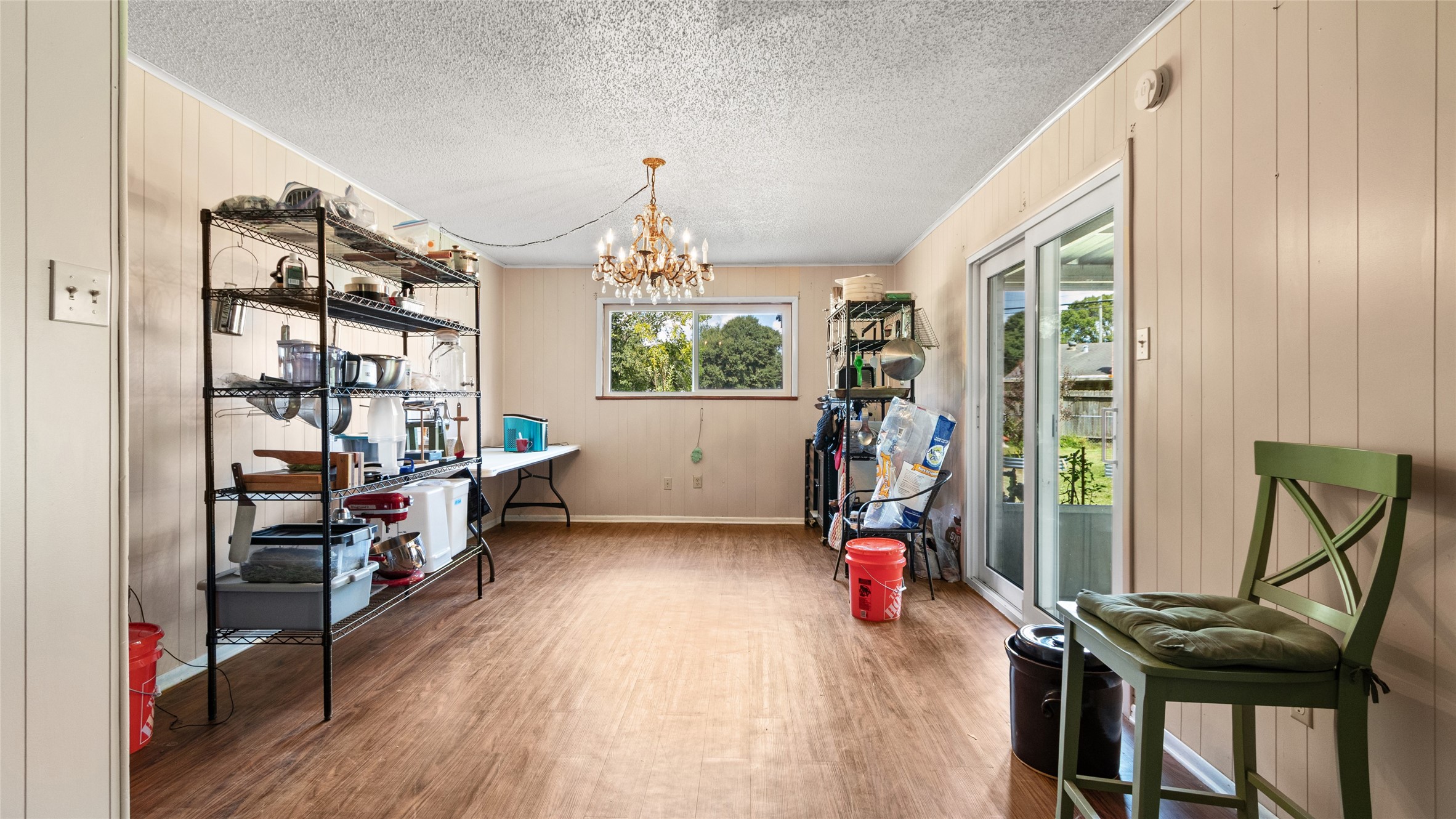 Formal dining area offers generous space for entertaining, abundant natural light, and direct access to the covered patio for easy indoor-outdoor living.