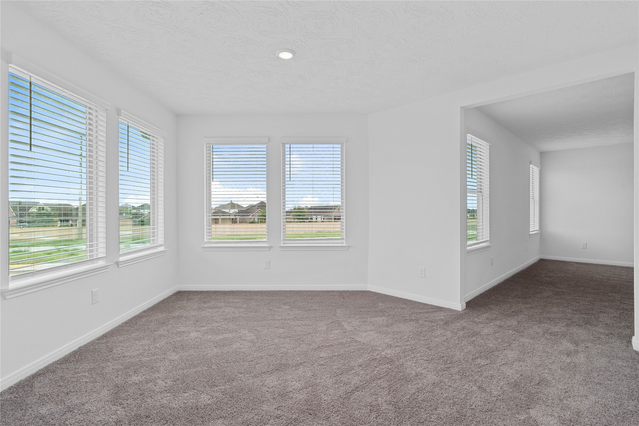 Another view from the primary bedroom looking to the sitting area that leads to the primary bathroom.