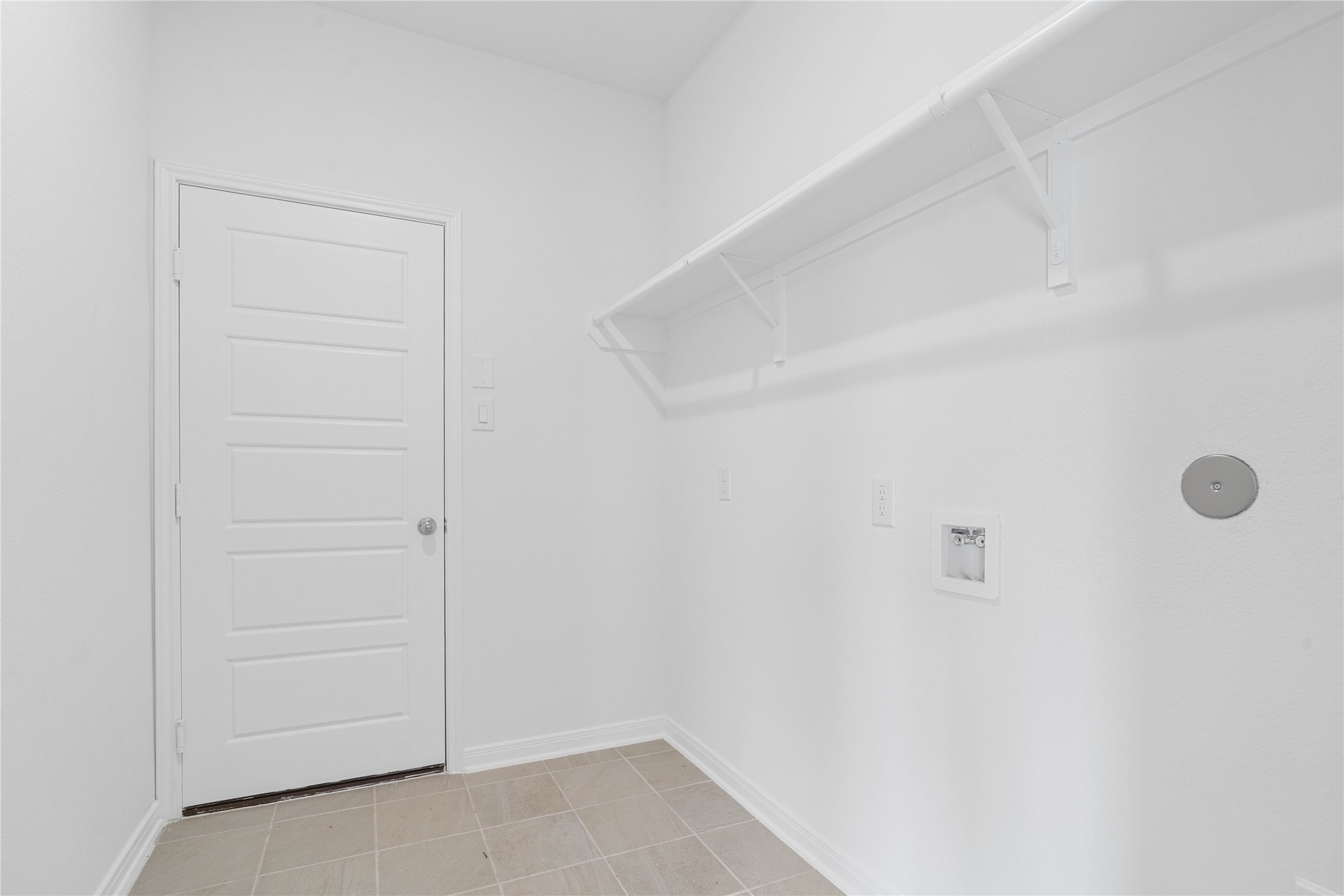 Laundry room conveniently located next to the garage.