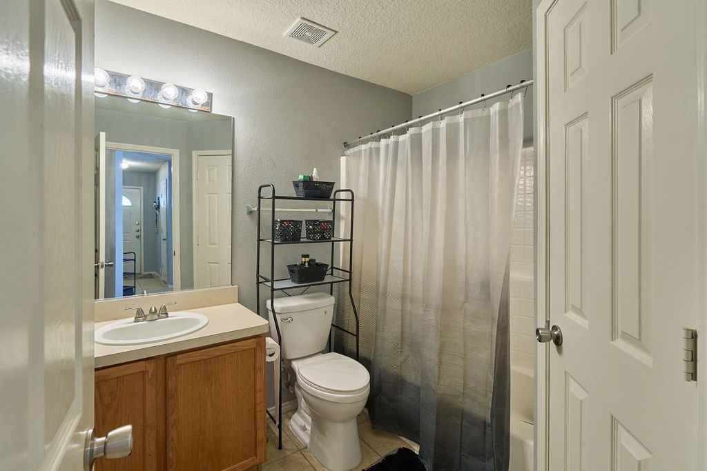 Fresh, functional, and thoughtfully arranged with a shower/tub combination and convenient vanity storage.