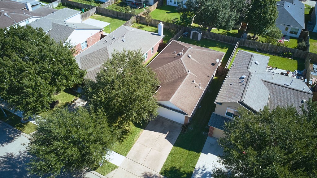 A bird's-eye perspective showcasing the home's setting, surrounding neighborhood, and established streetscape.
