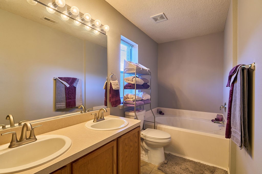 Start and end your day in comfort with this conveniently designed bathroom featuring a generous vanity.