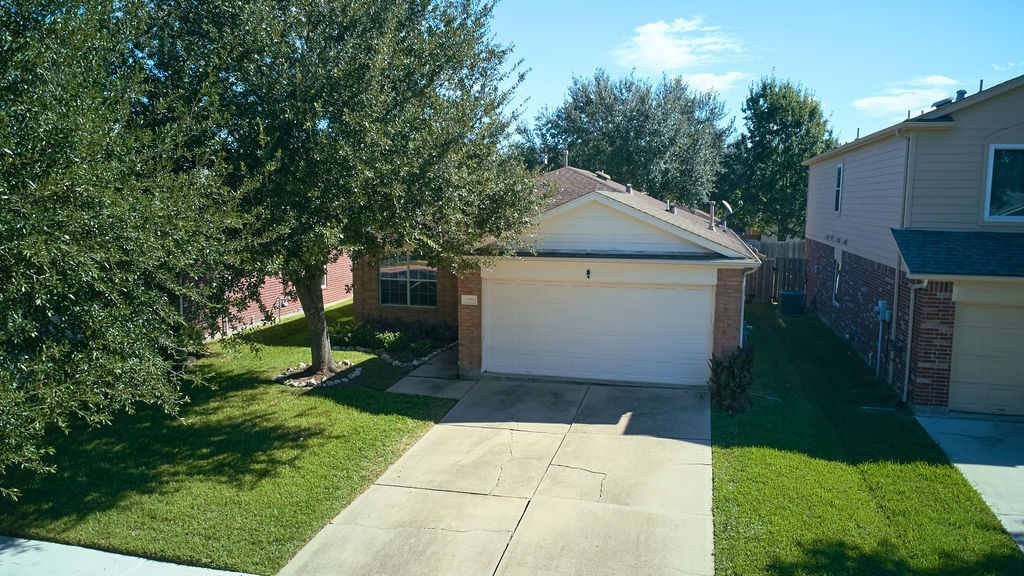 Arrive home to a welcoming driveway, attached garage, and the natural beauty of mature surrounding trees. Arrive home to a welcoming driveway, attached garage, and the natural beauty of mature surrounding trees.