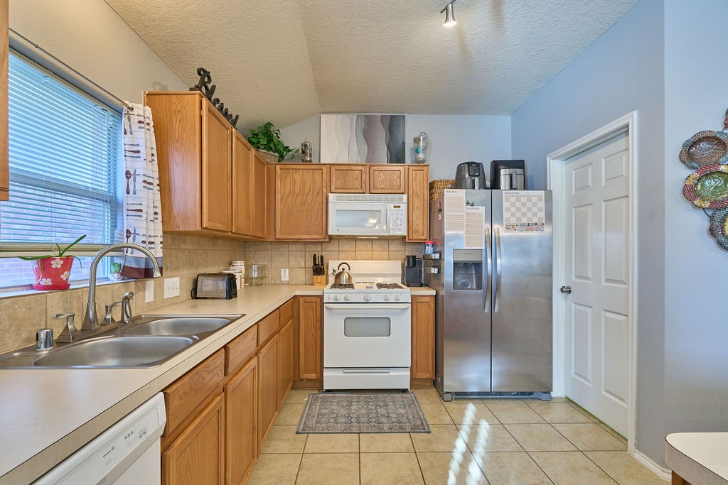 The heart of the home! A spacious kitchen featuring abundant cabinetry, generous countertops, and practical functionality. The heart of the home! A spacious kitchen featuring abundant cabinetry, generous countertops, and practical functionality.
