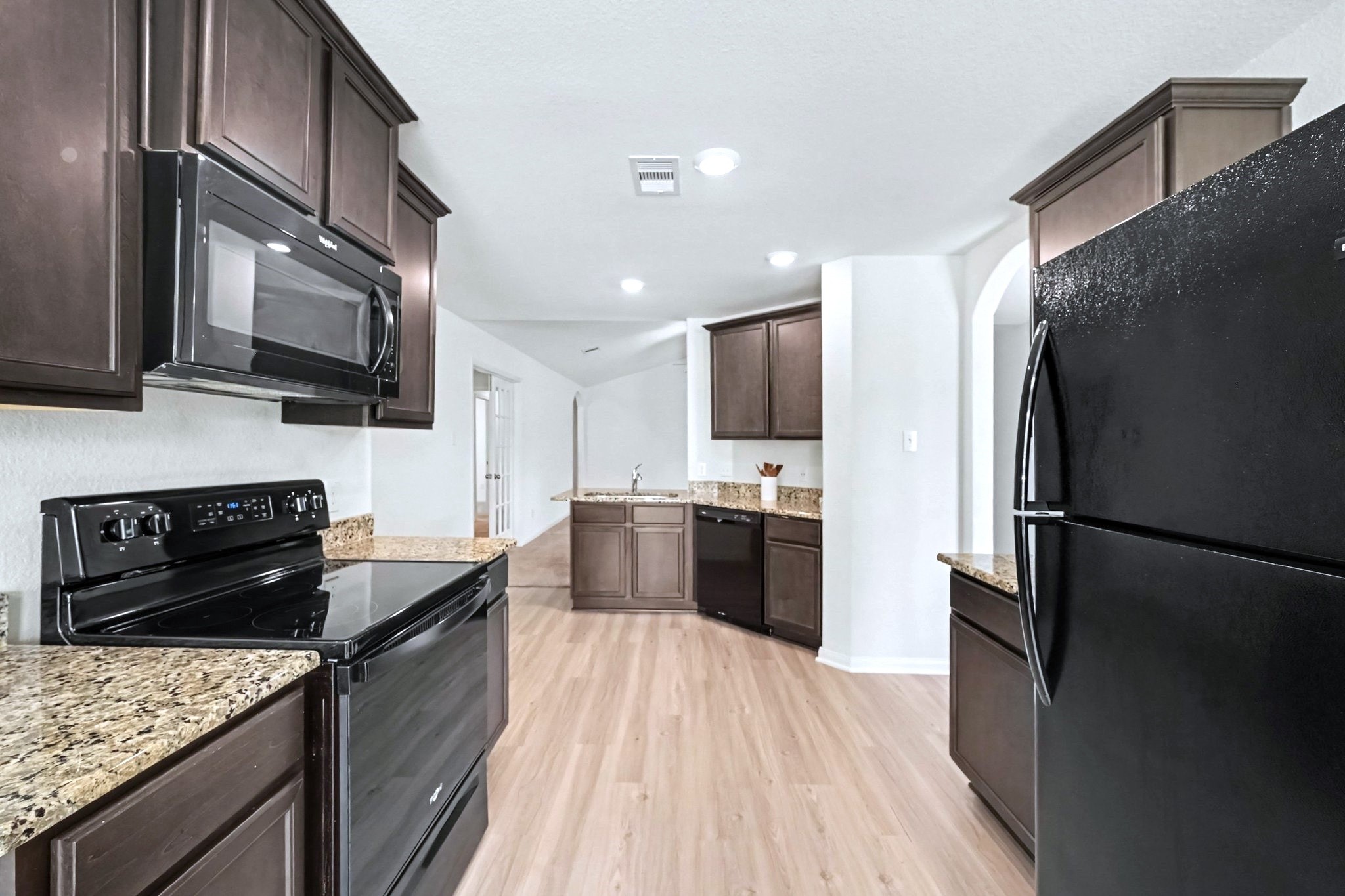 Another view of the flow between breakfast/dining nook and kitchen and living space