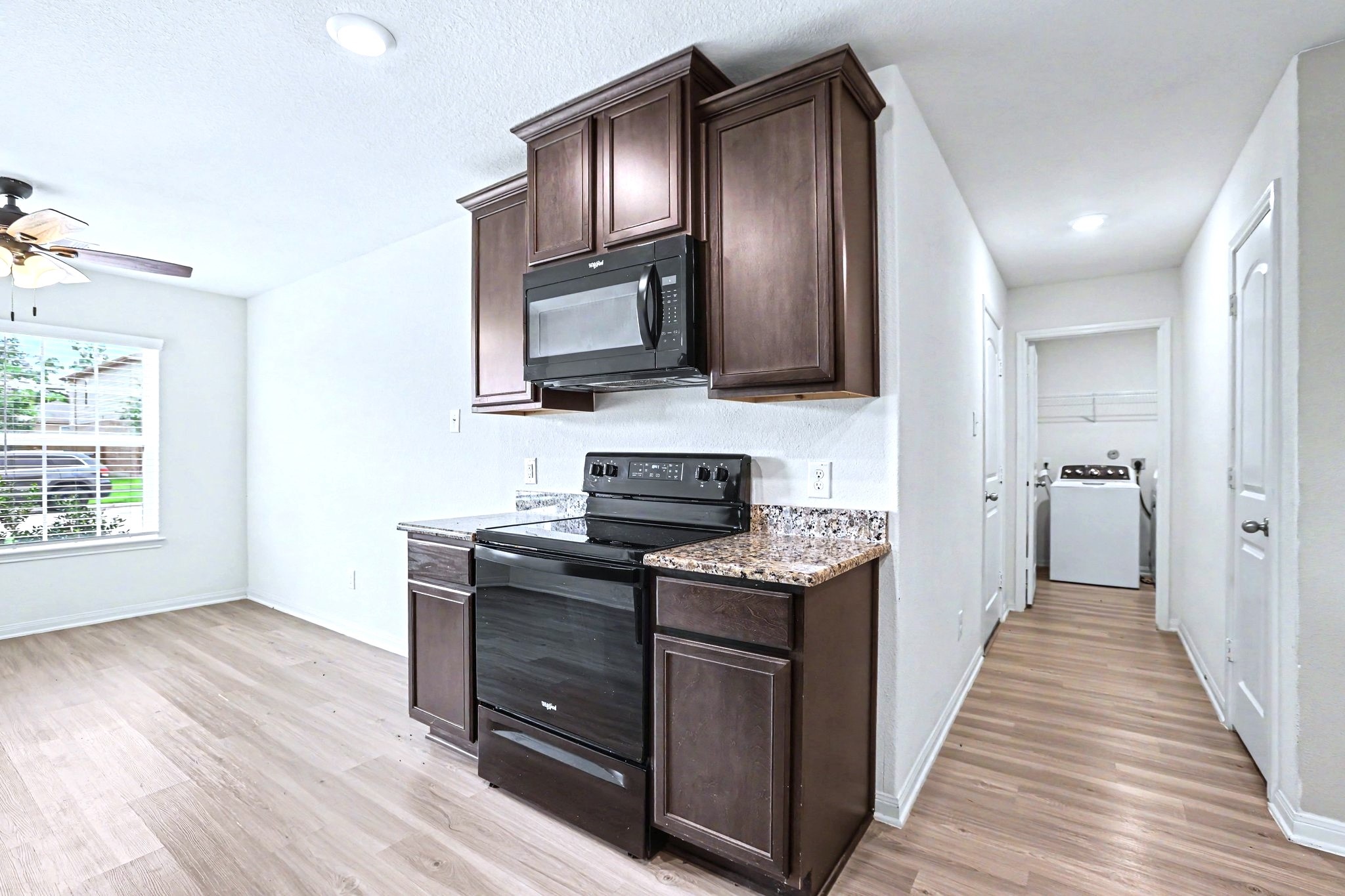 The utility room is right down the hall from the kitchen.