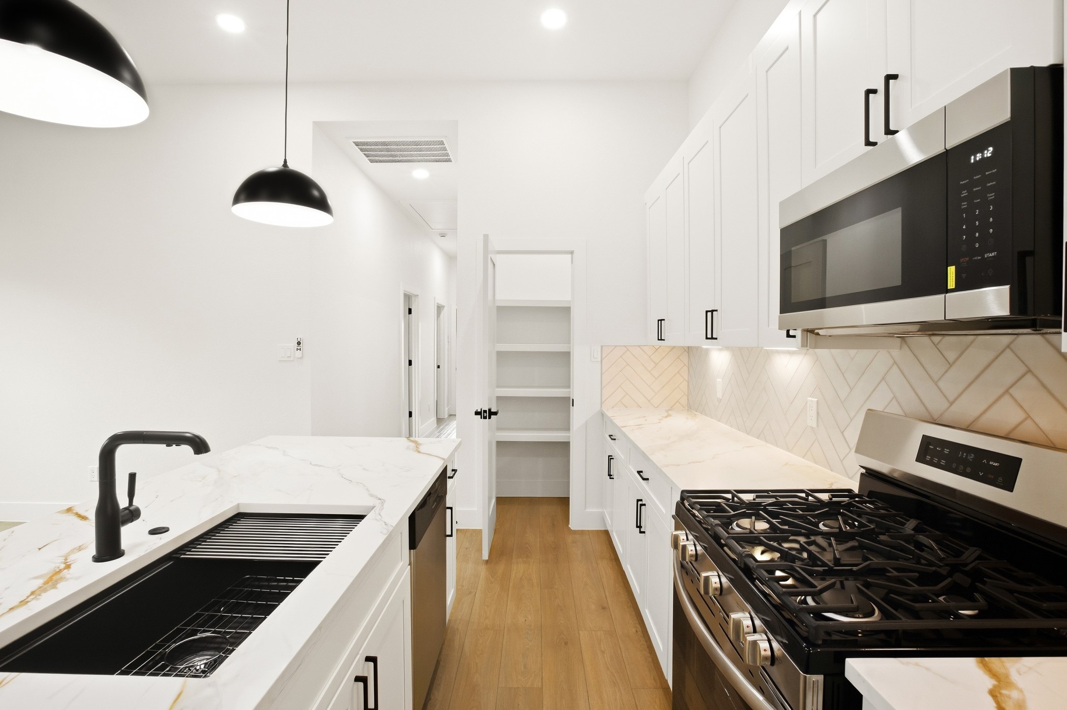 Refined kitchen with modern fixtures and crisp white cabinetry.