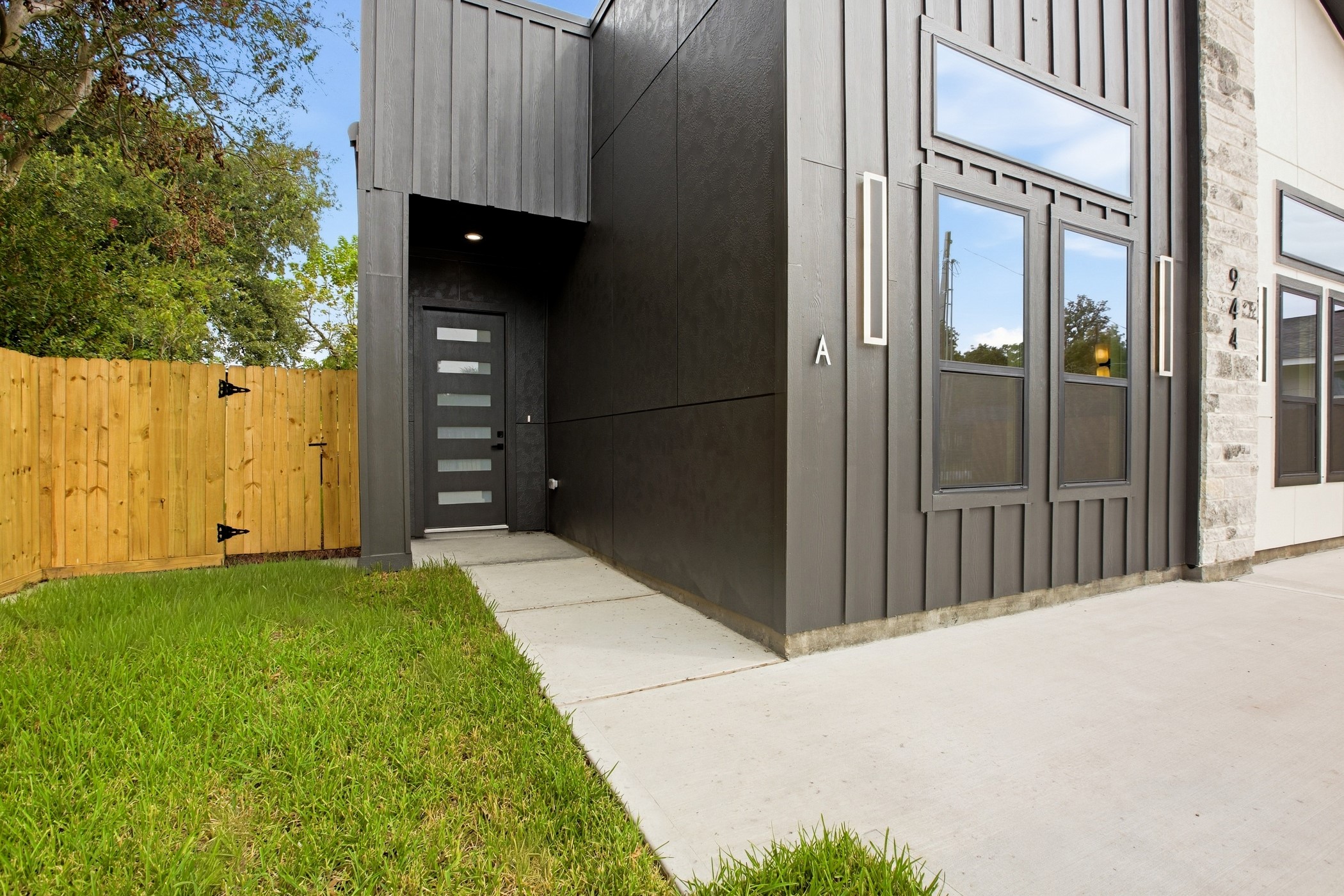 Modern entry with bold detailing and expansive windows.
