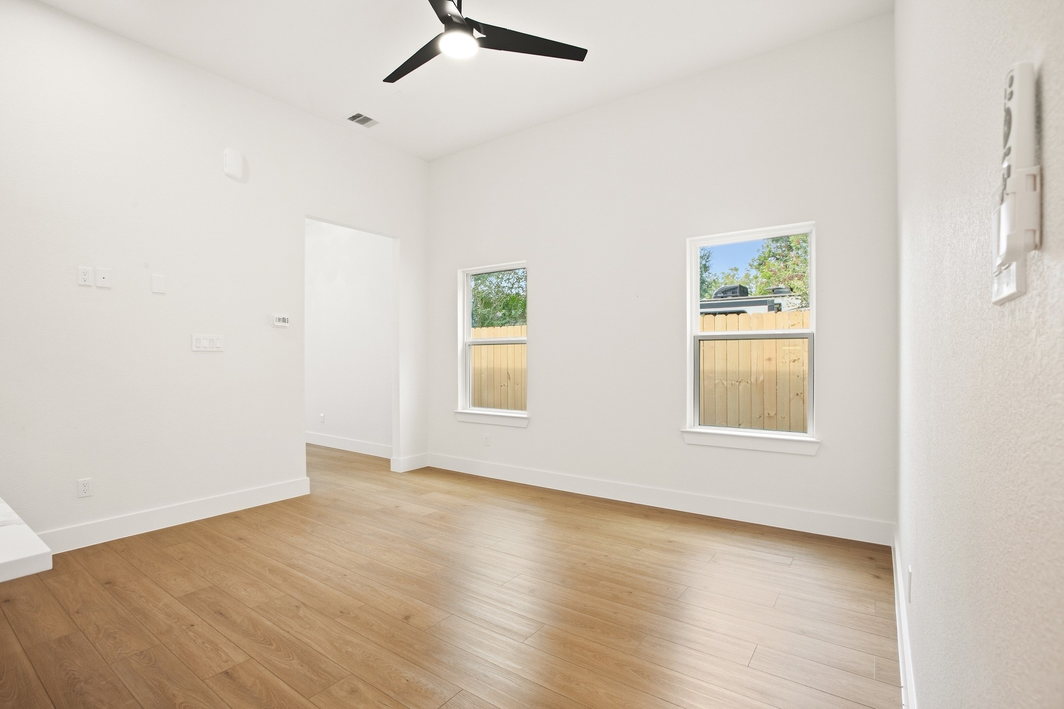Bright flex space with warm wood flooring and natural light.
