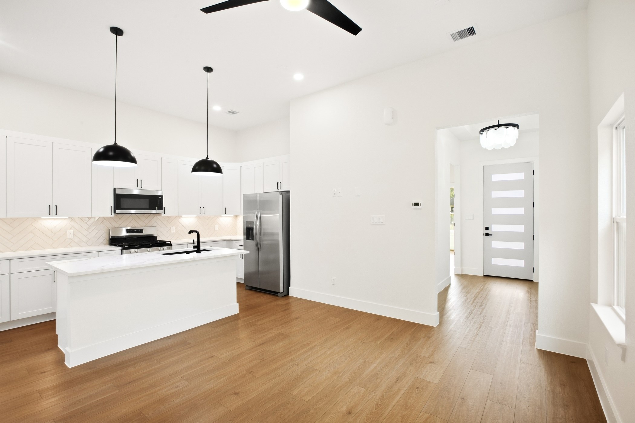 Open-concept kitchen designed around a spacious central island.