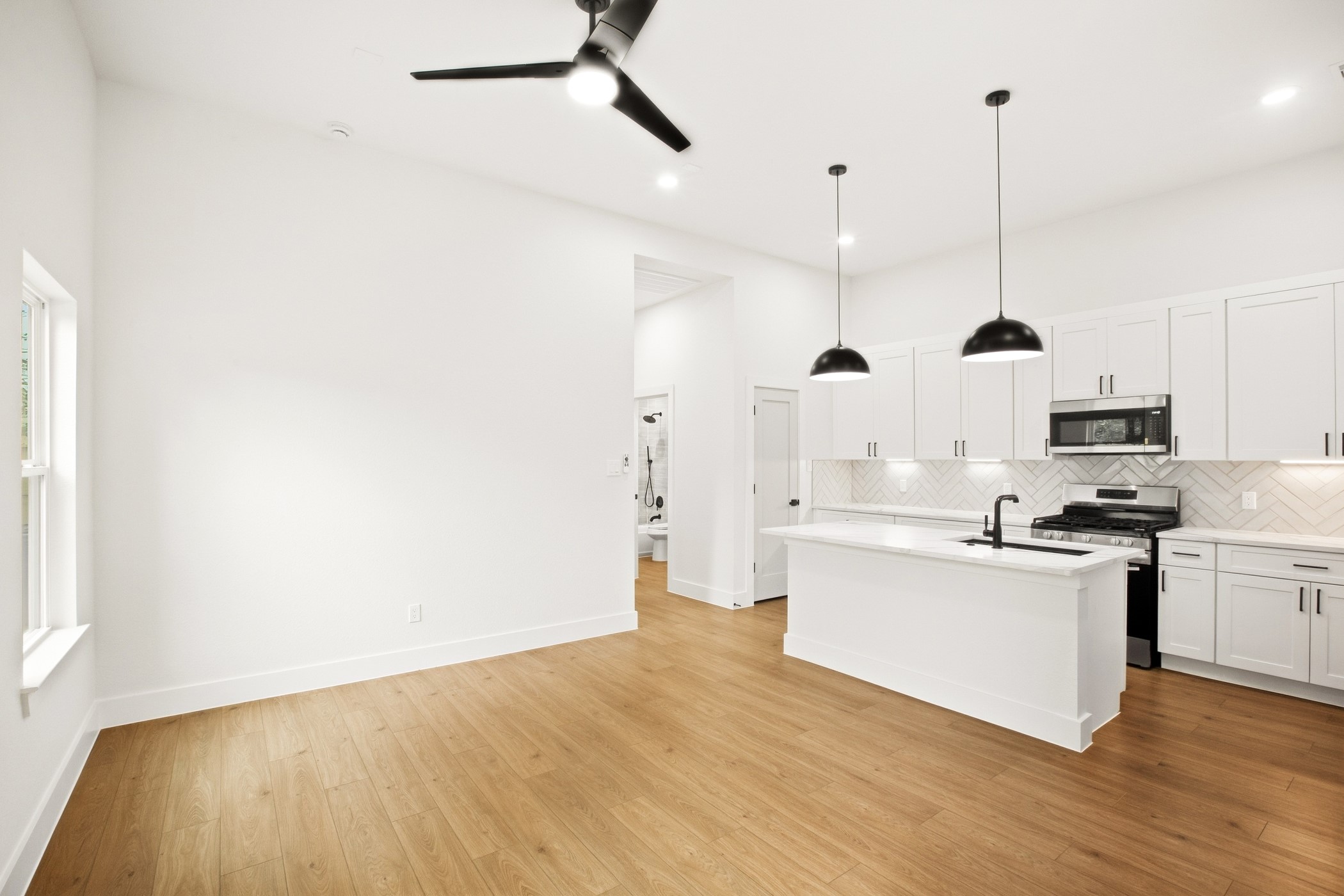 Contemporary kitchen with sleek cabinetry and stylish pendant lighting.