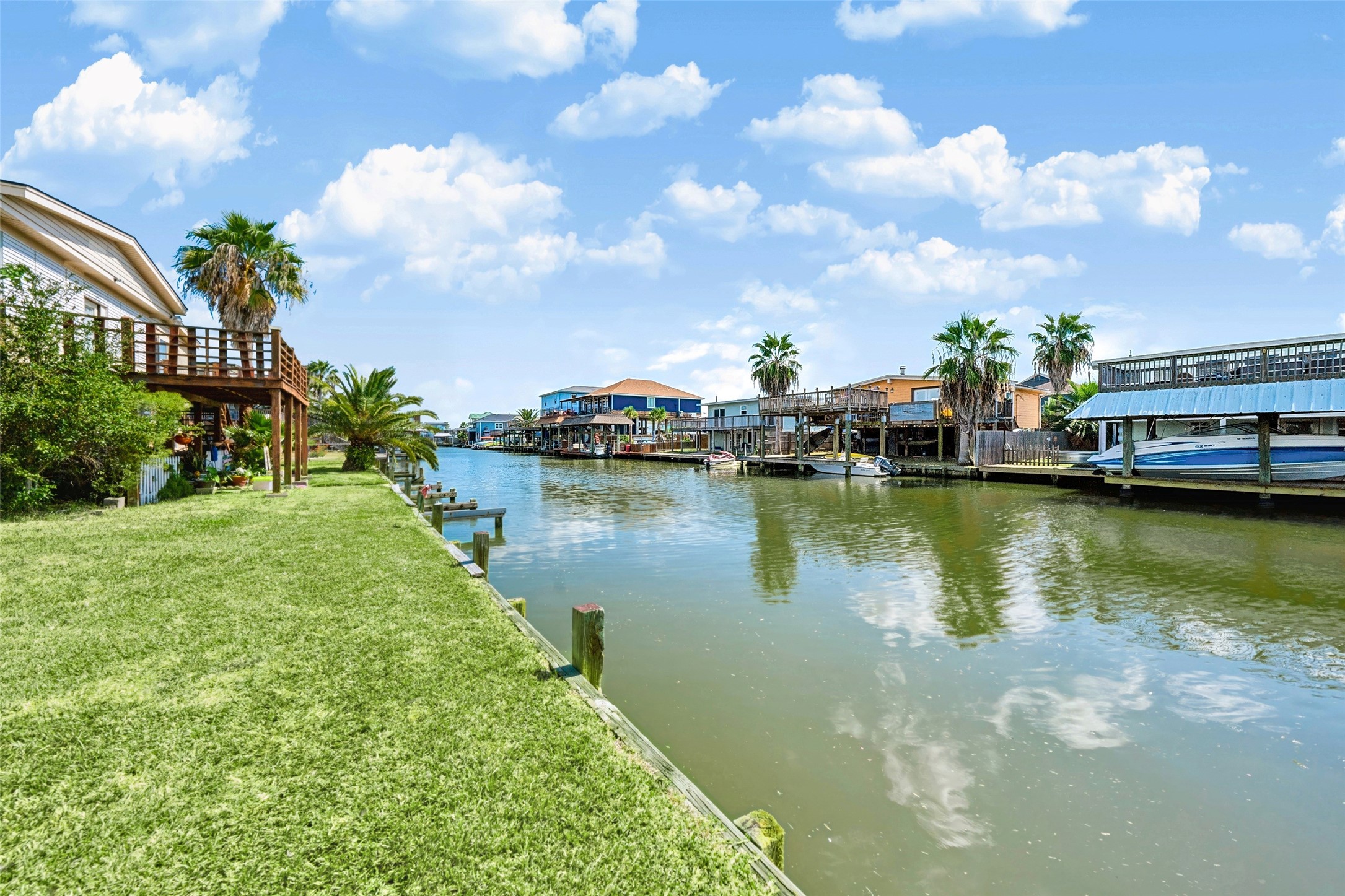 Canal view along the bulkhead, with homes and docks across the way. Quick run out to the bay! Tiki Island Tavern is about 3.1 miles away for a cold drink after.